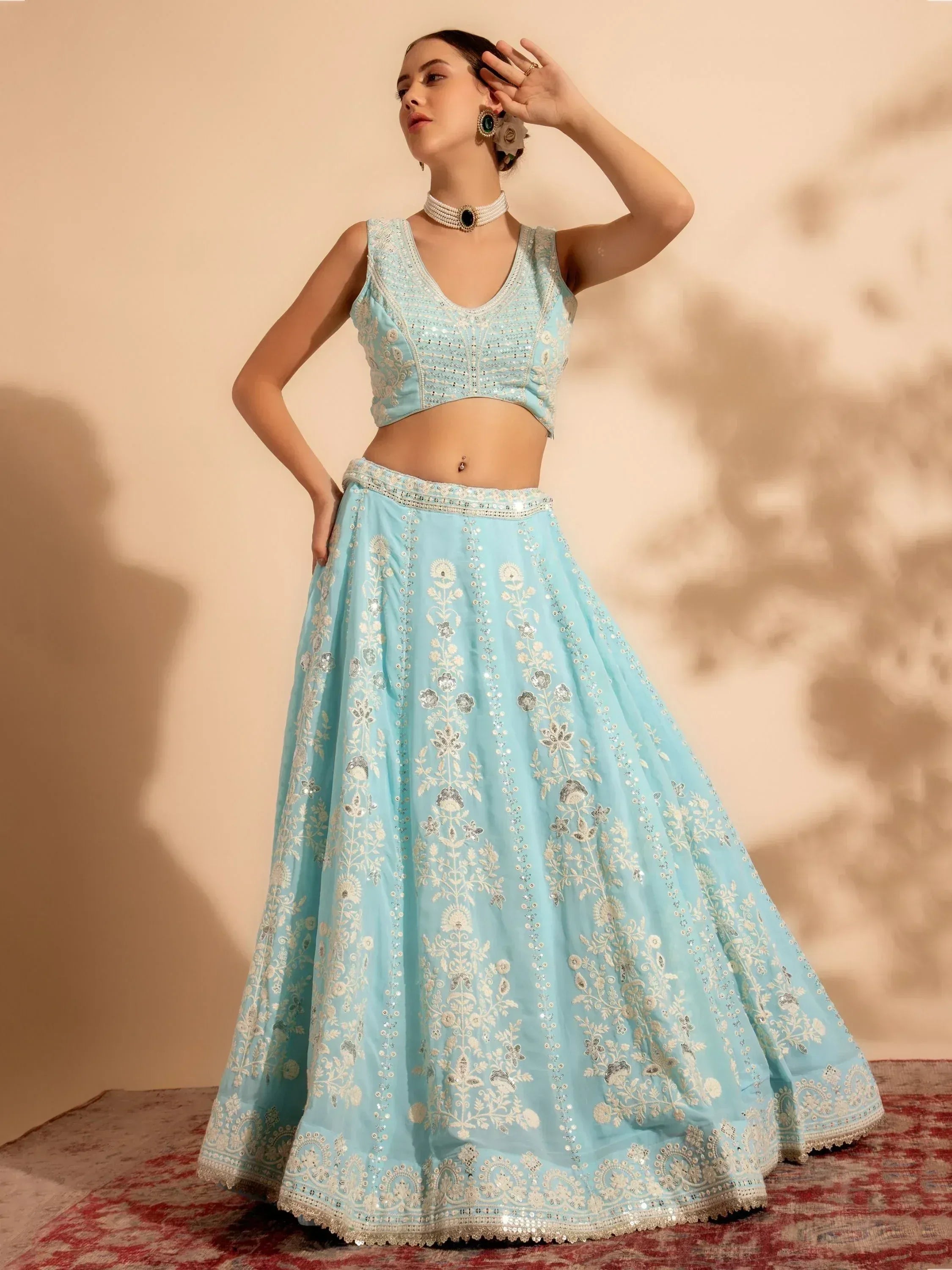 Light blue embroidered lehenga choli with floral motifs, perfect for Indian ethnic wear events