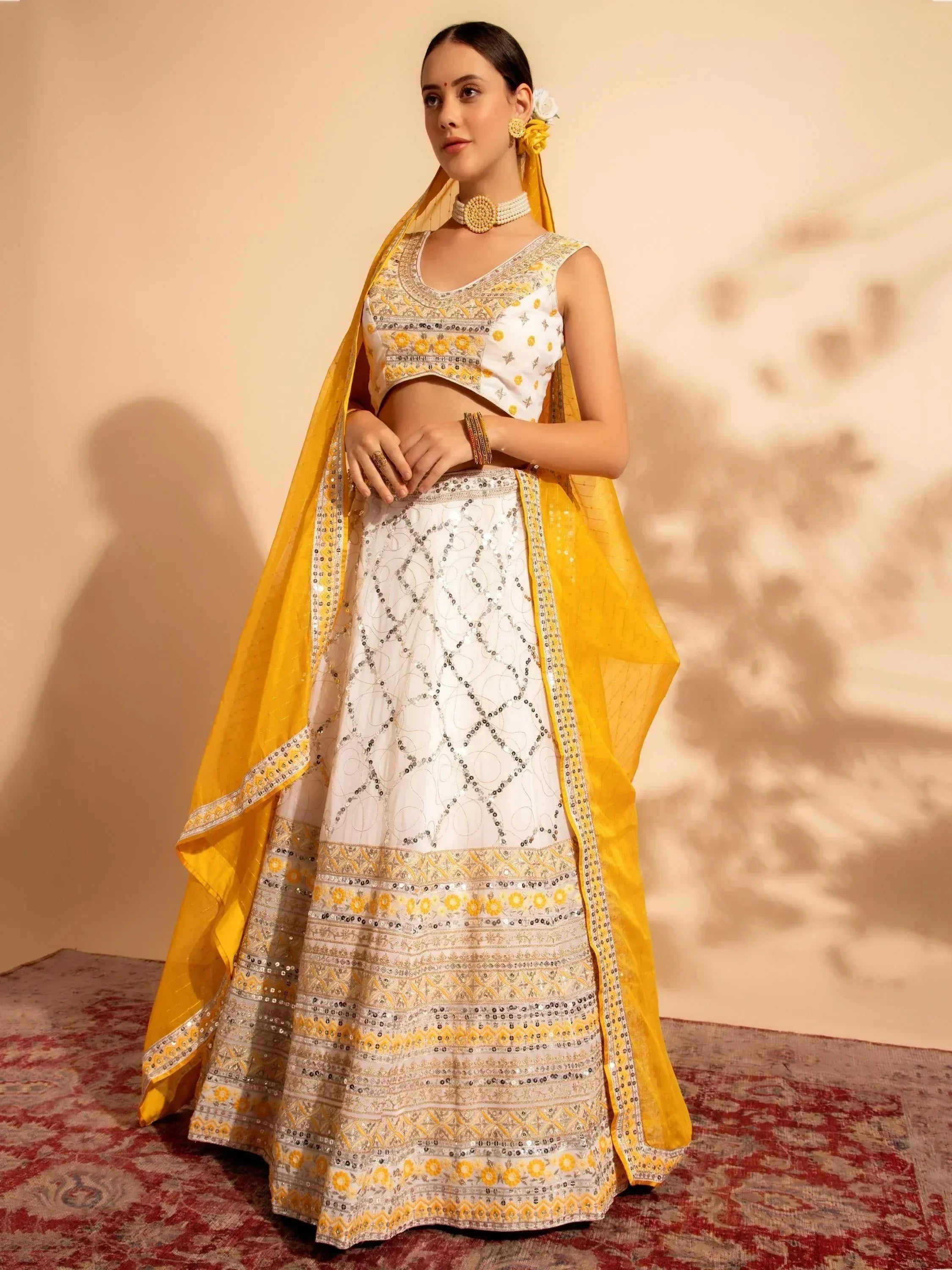 White and yellow embroidered lehenga choli with sequin work and matching dupatta, perfect for Indian ethnic occasions.
