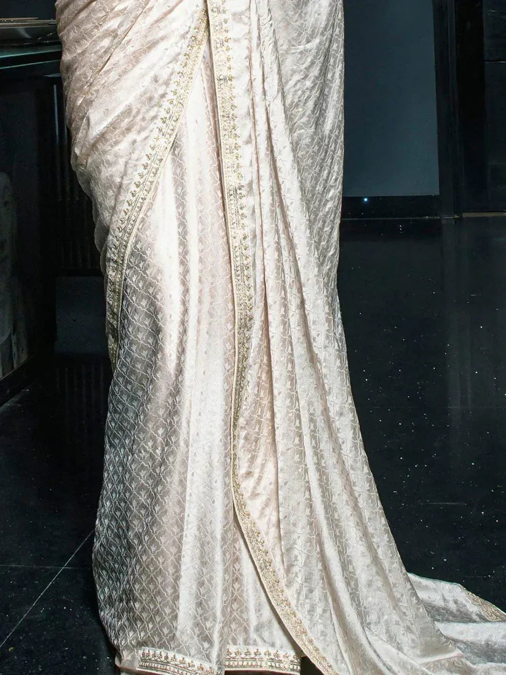 Elegant ivory silk saree with gold embroidery, perfect for Indian ethnic wear occasions.