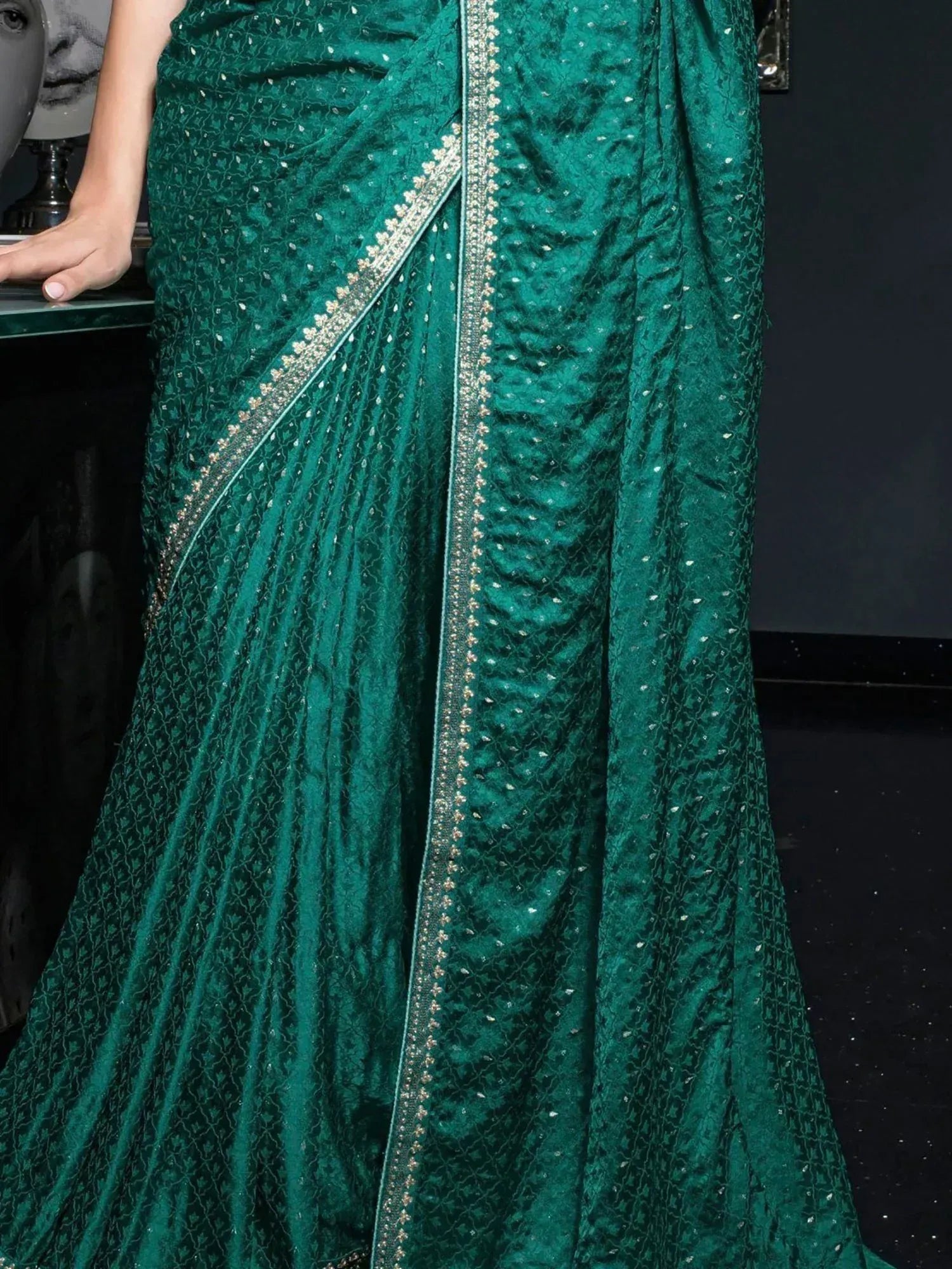 Emerald green velvet saree with gold embroidery and sequin detailing, perfect for Indian ethnic wear occasions.