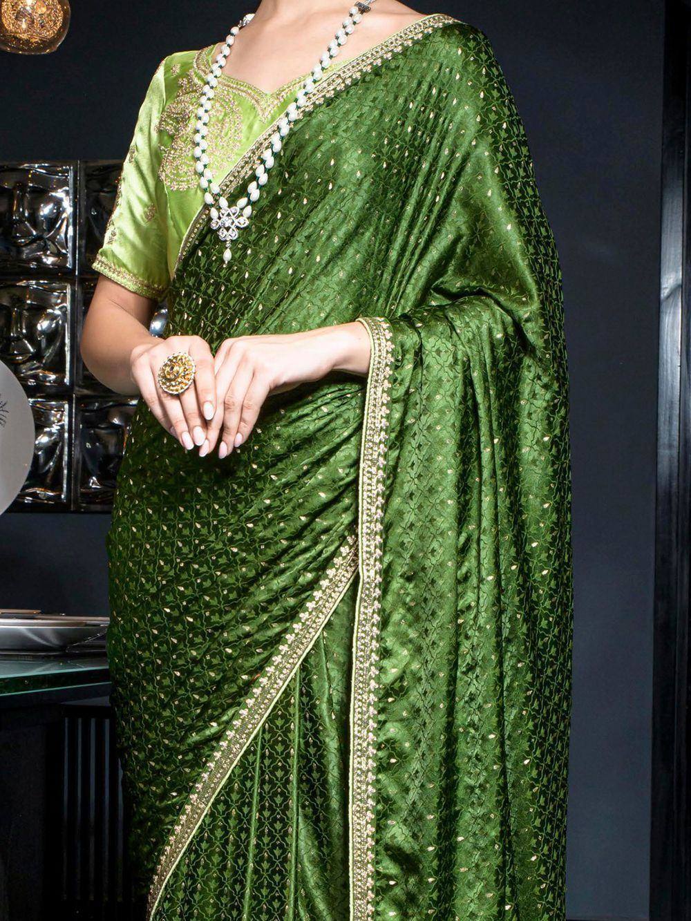 Emerald green designer saree with gold embroidery and matching blouse, perfect for Indian ethnic occasions.