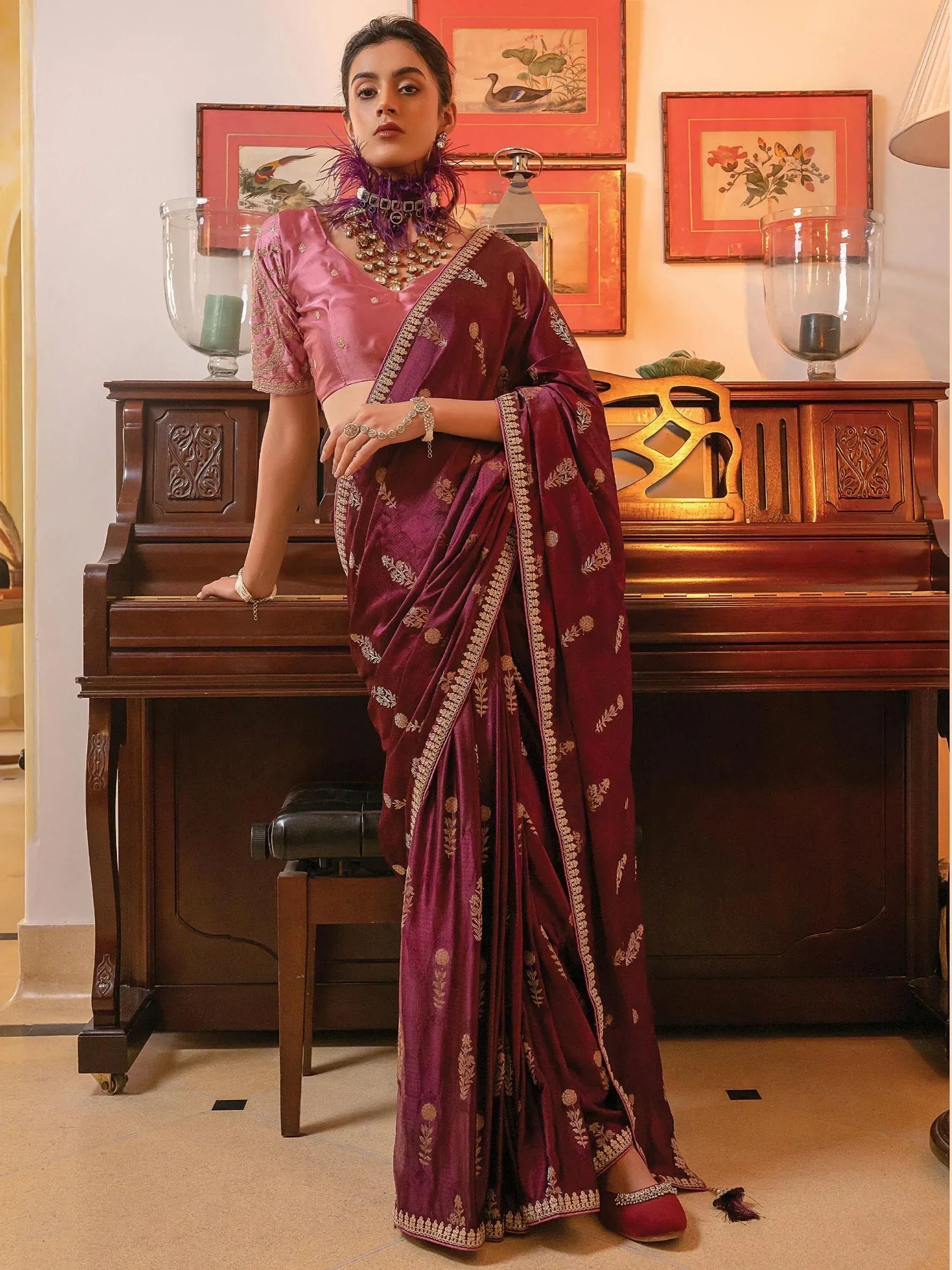 Elegant maroon silk saree with gold embroidery, paired with pink blouse, perfect for Indian ethnic occasions.