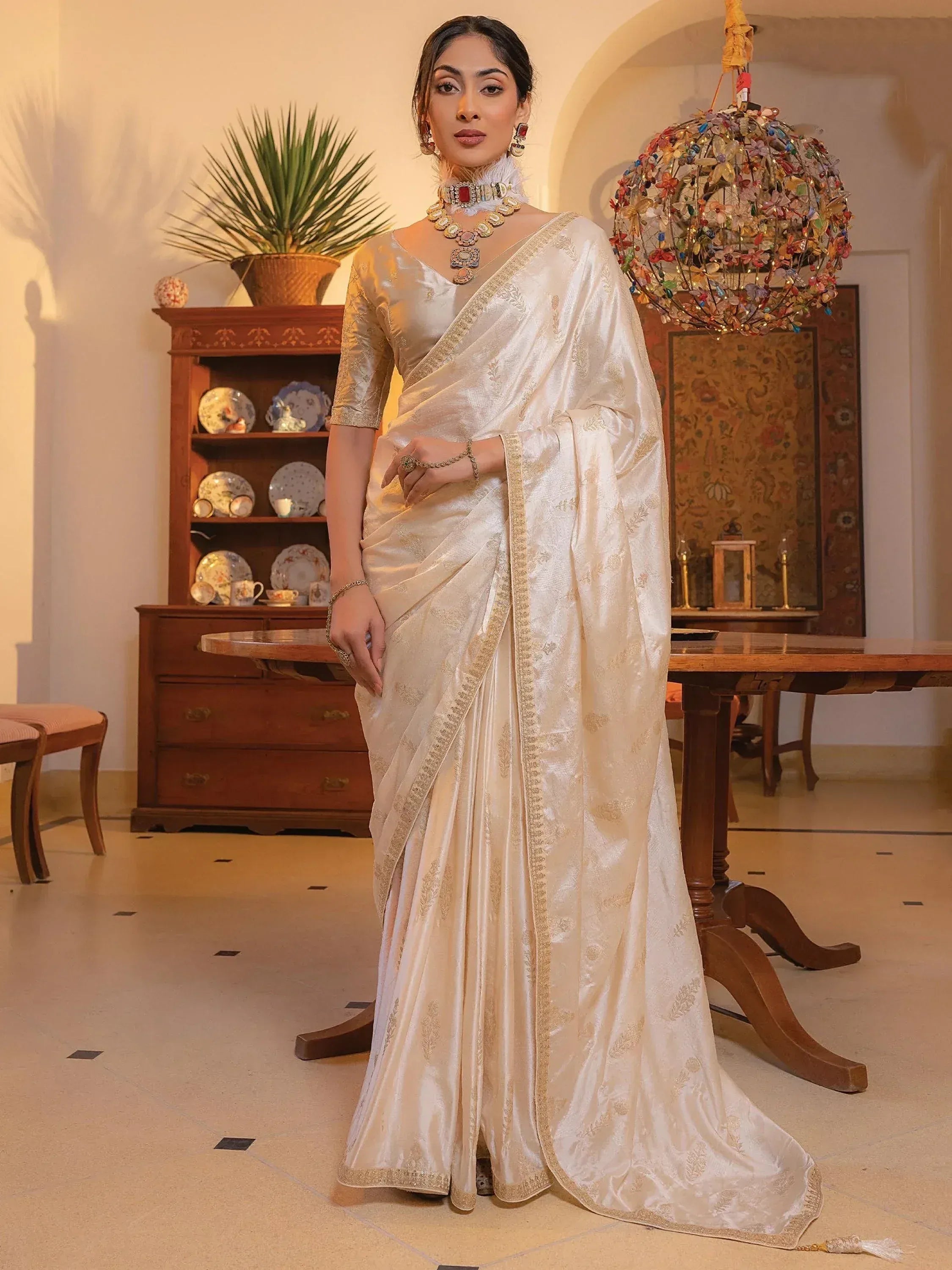 Elegant ivory silk saree with gold embroidery, perfect for Indian ethnic wear and festive occasions.