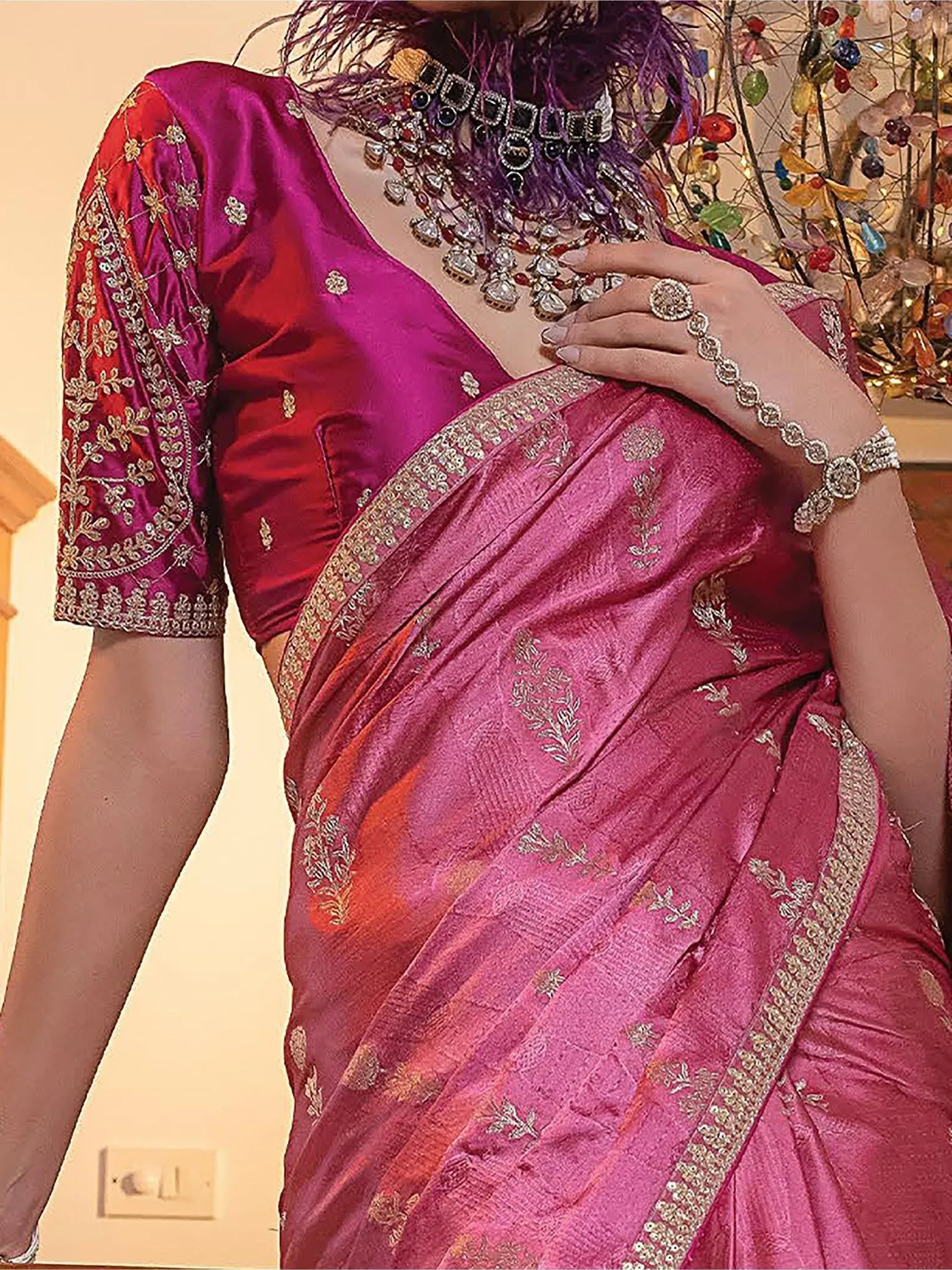 Pink embroidered saree with gold detailing, paired with matching blouse and traditional jewelry