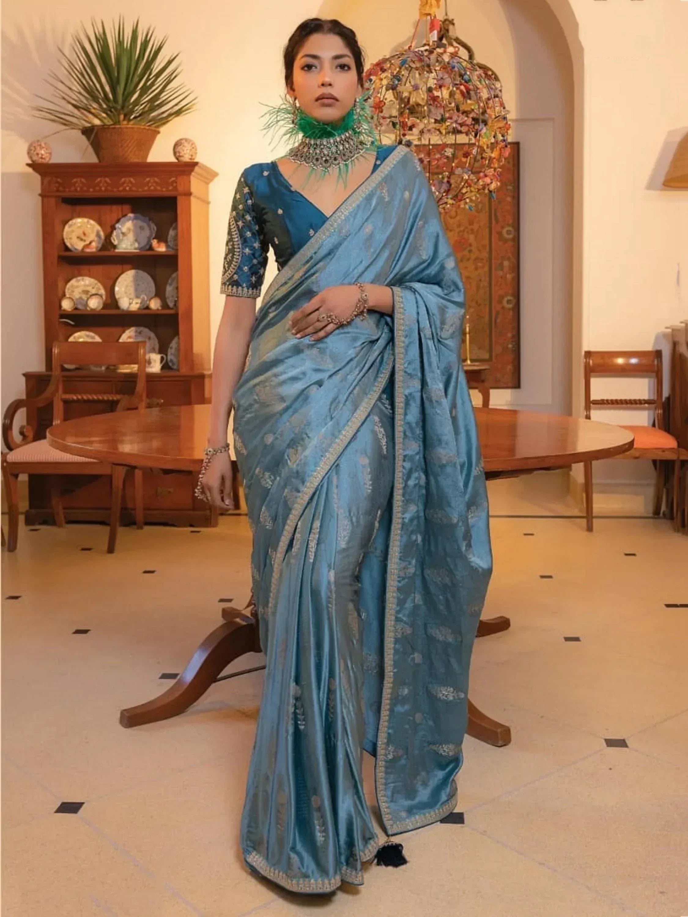 Blue silk saree with gold embroidery, paired with a designer blouse and statement jewelry for ethnic wear.