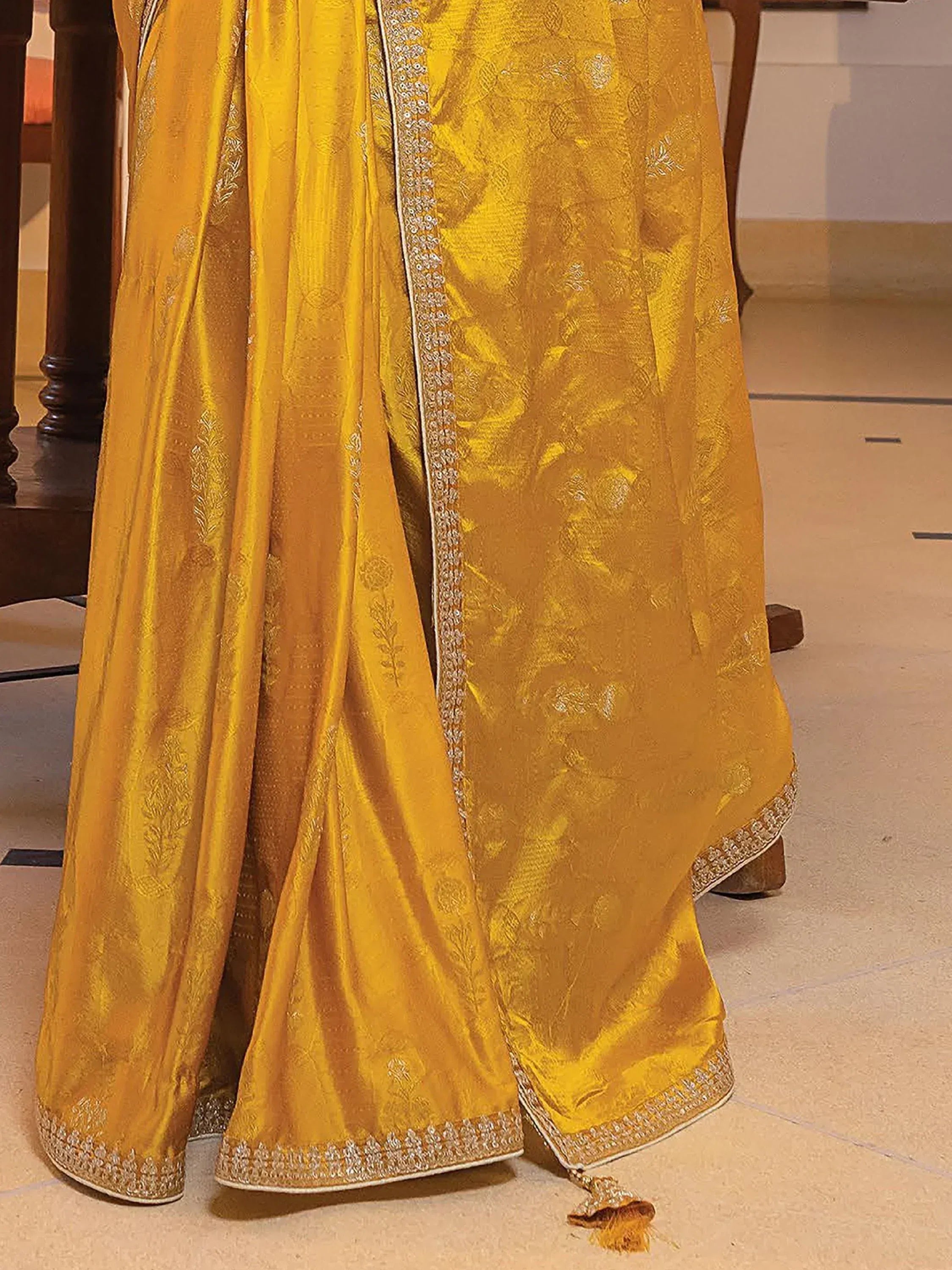 Golden designer lehenga choli with intricate embroidery and embellished borders for ethnic wear