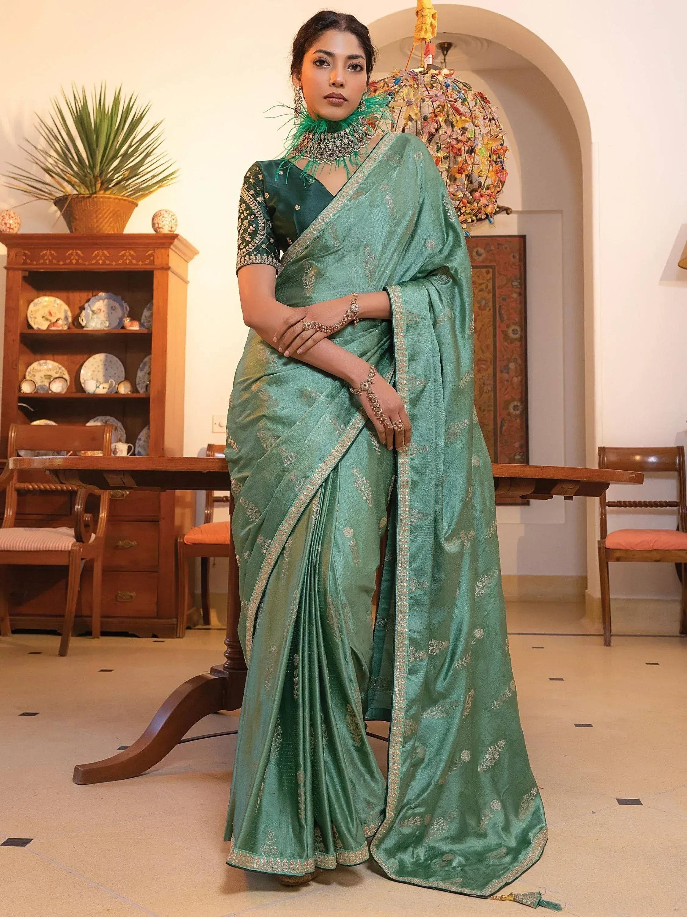 Elegant green designer saree with gold embroidery, perfect for Indian ethnic wear and festive occasions.