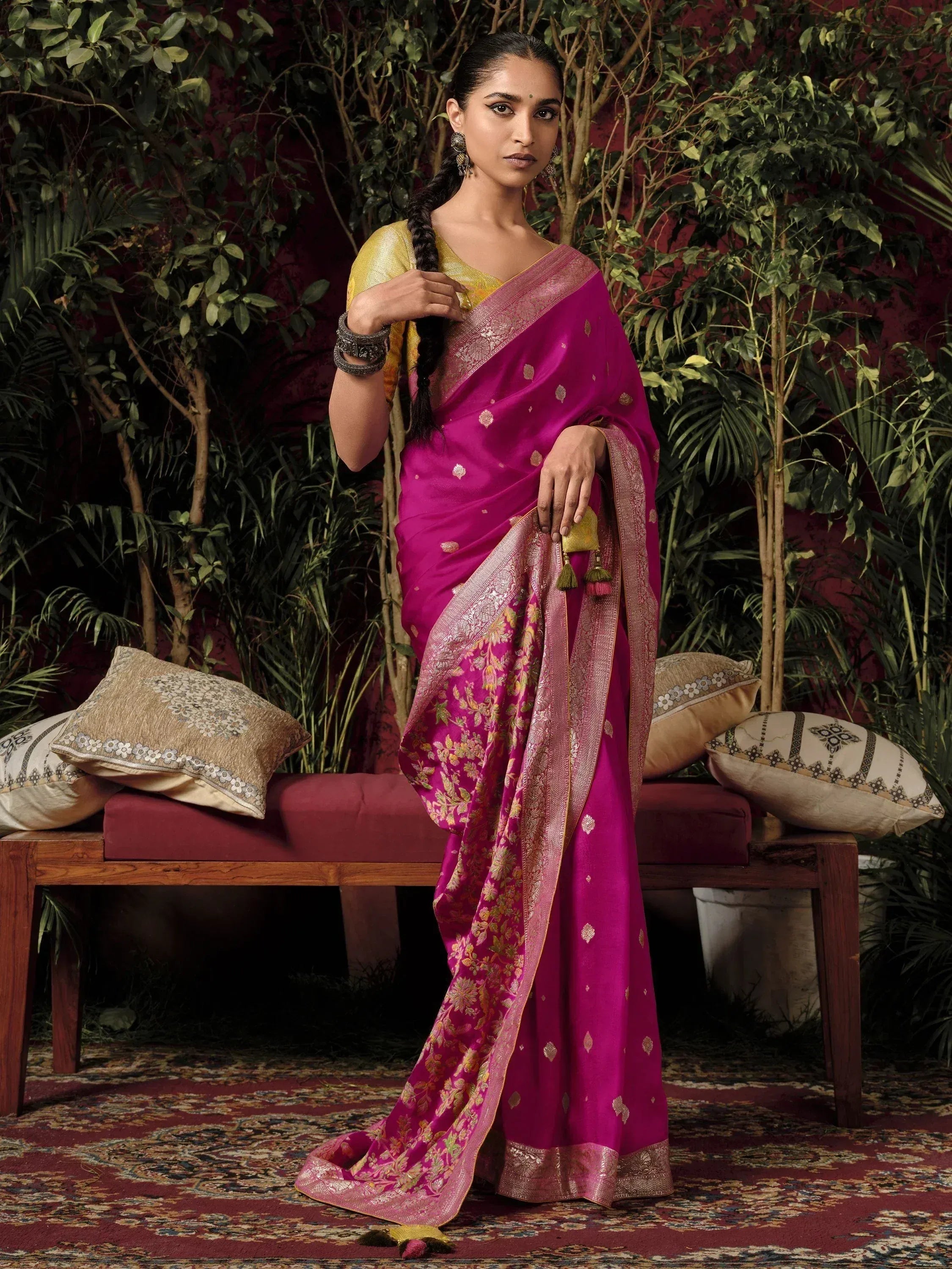 Woman in vibrant magenta silk saree with gold floral embroidery and border, paired with yellow blouse, traditional Indian ethnic wear