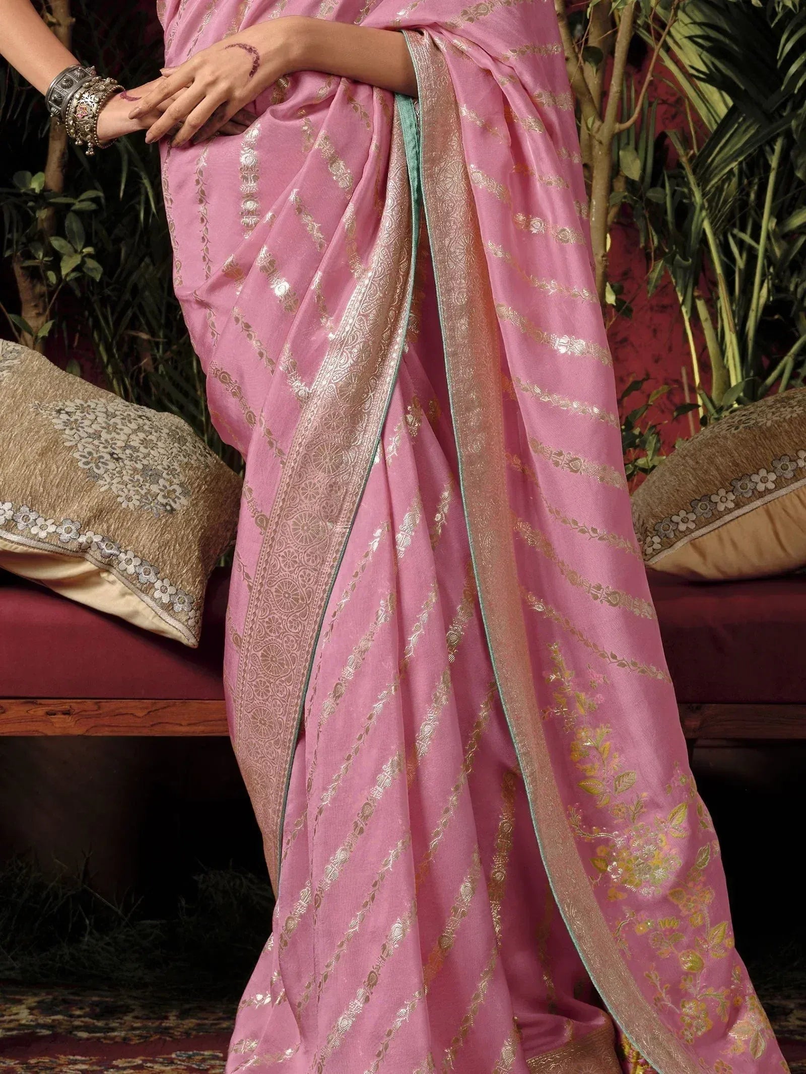 Pink designer saree with gold zari work and floral motifs, perfect for ethnic occasions