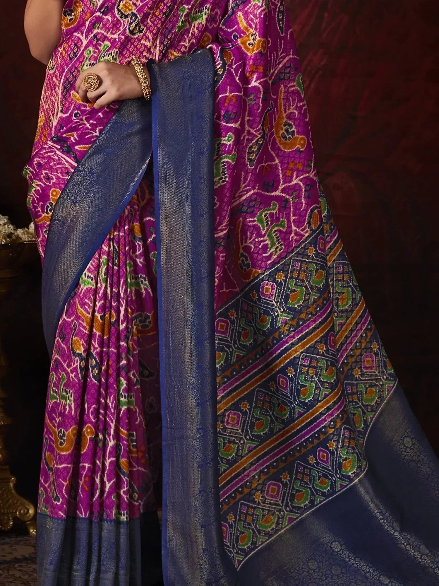 Vibrant purple and blue ethnic saree with intricate animal and geometric prints, perfect for traditional occasions.