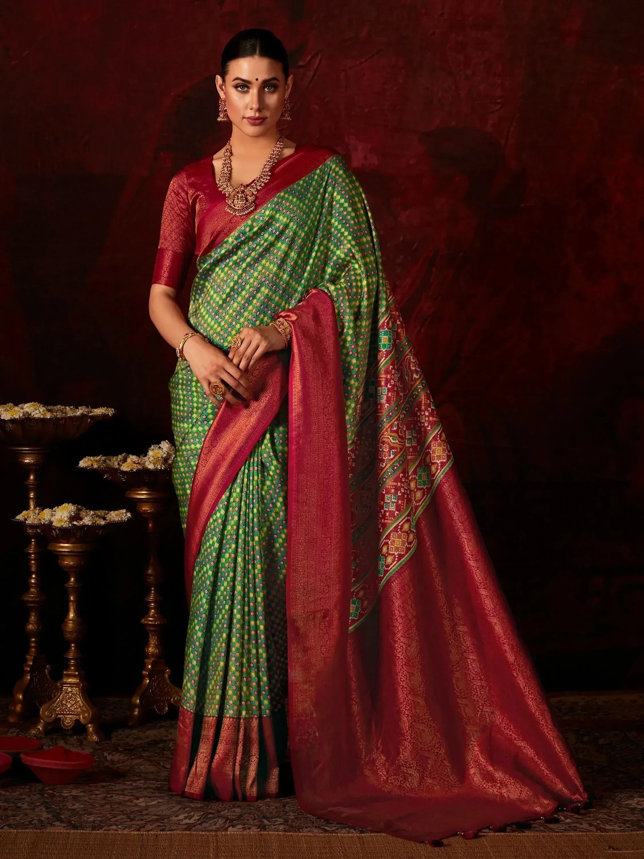 Green and red ethnic saree with intricate patterns, perfect for Indian festive occasions and weddings.
