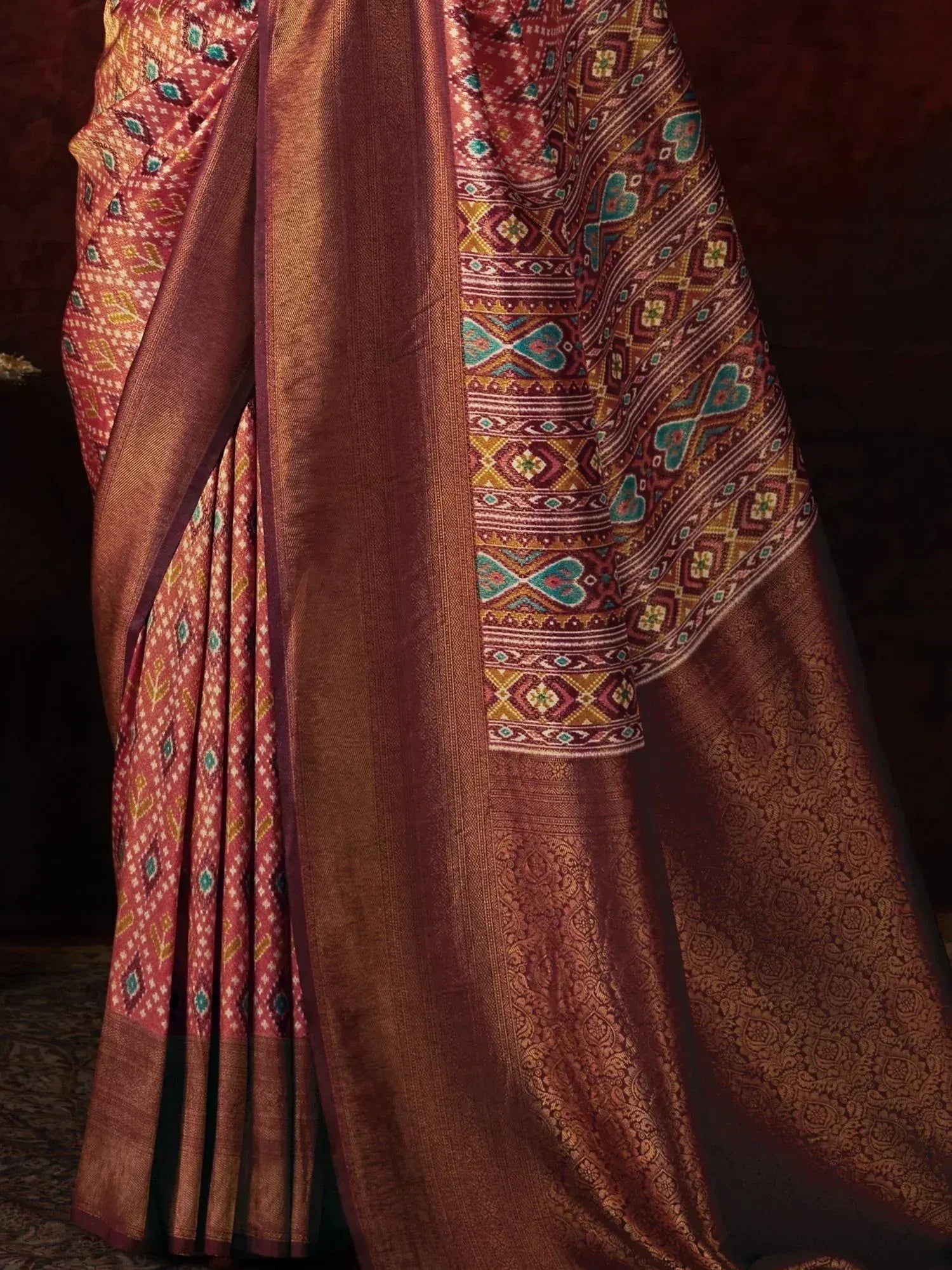 Rich maroon ethnic saree with intricate geometric and floral patterns, perfect for traditional Indian occasions.