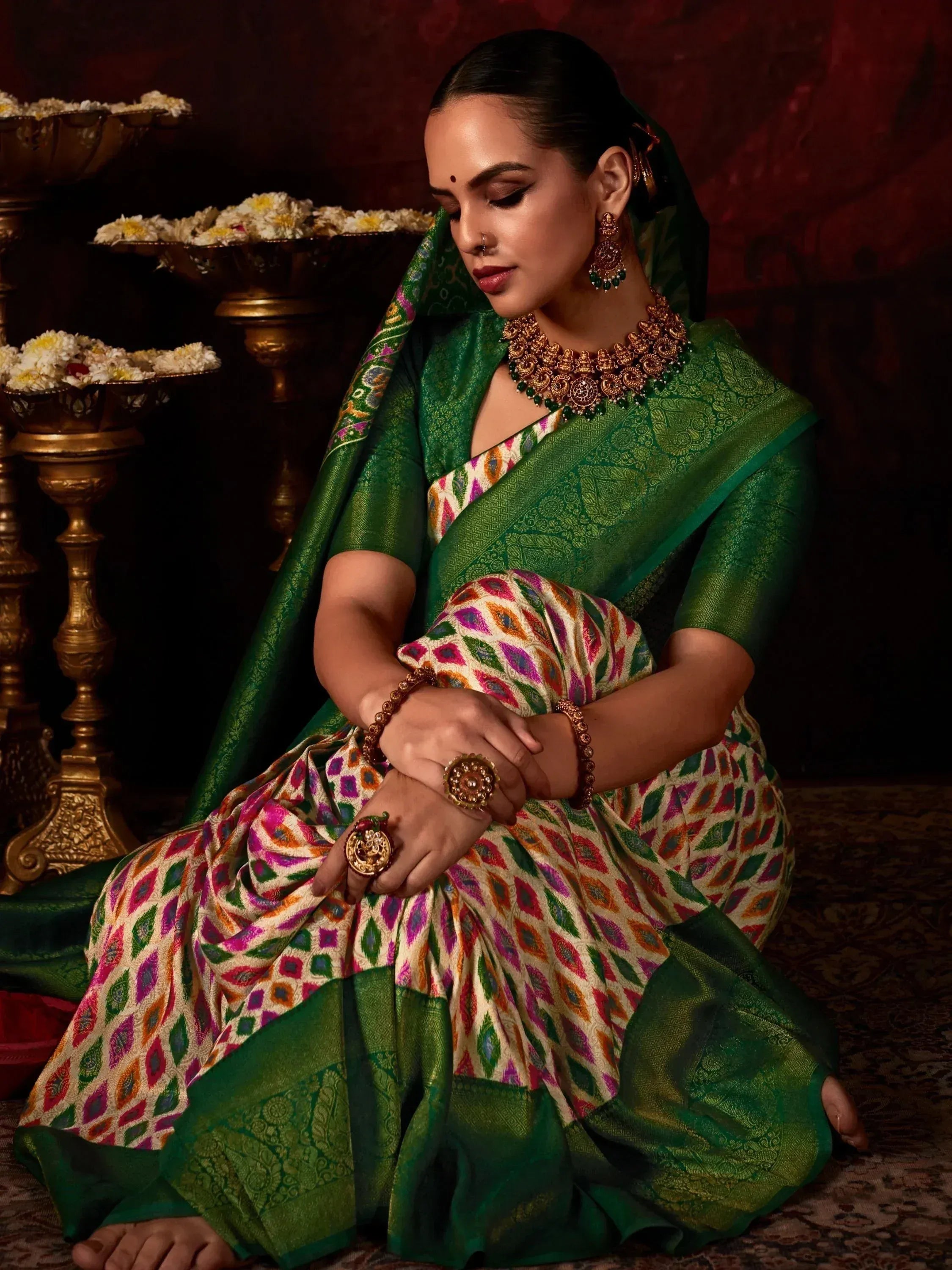 Elegant woman in green and multicolor designer saree with gold jewelry, traditional Indian ethnic wear