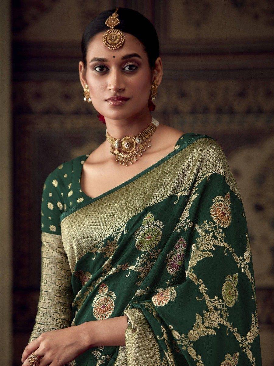 Elegant green and gold embroidered saree with traditional Indian jewelry, perfect for festive occasions.