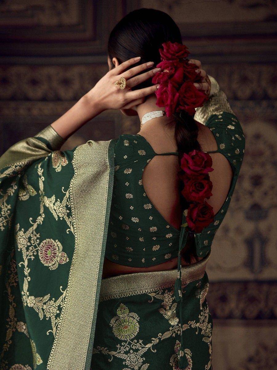 Elegant green saree with gold embroidery, floral hair accessory, and backless blouse for Indian ethnic wear