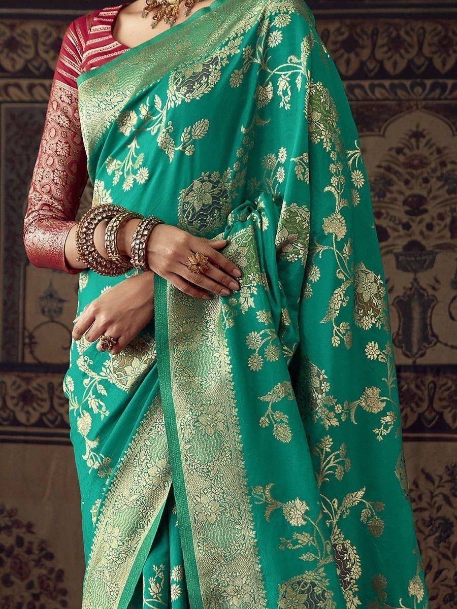 Emerald green designer saree with gold floral embroidery, paired with red blouse, perfect for Indian ethnic wear occasions