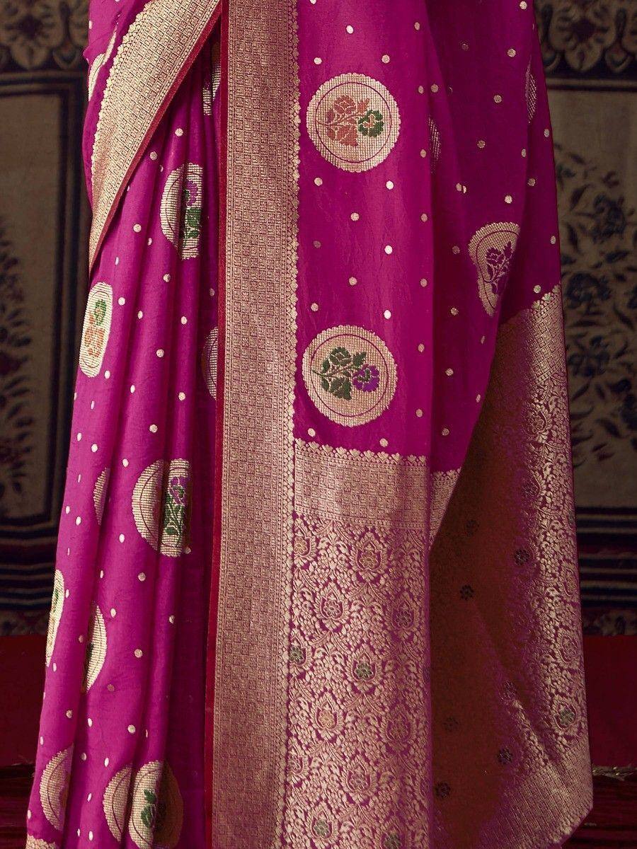 Vibrant magenta saree with floral motifs and gold zari border, ideal for Indian ethnic occasions