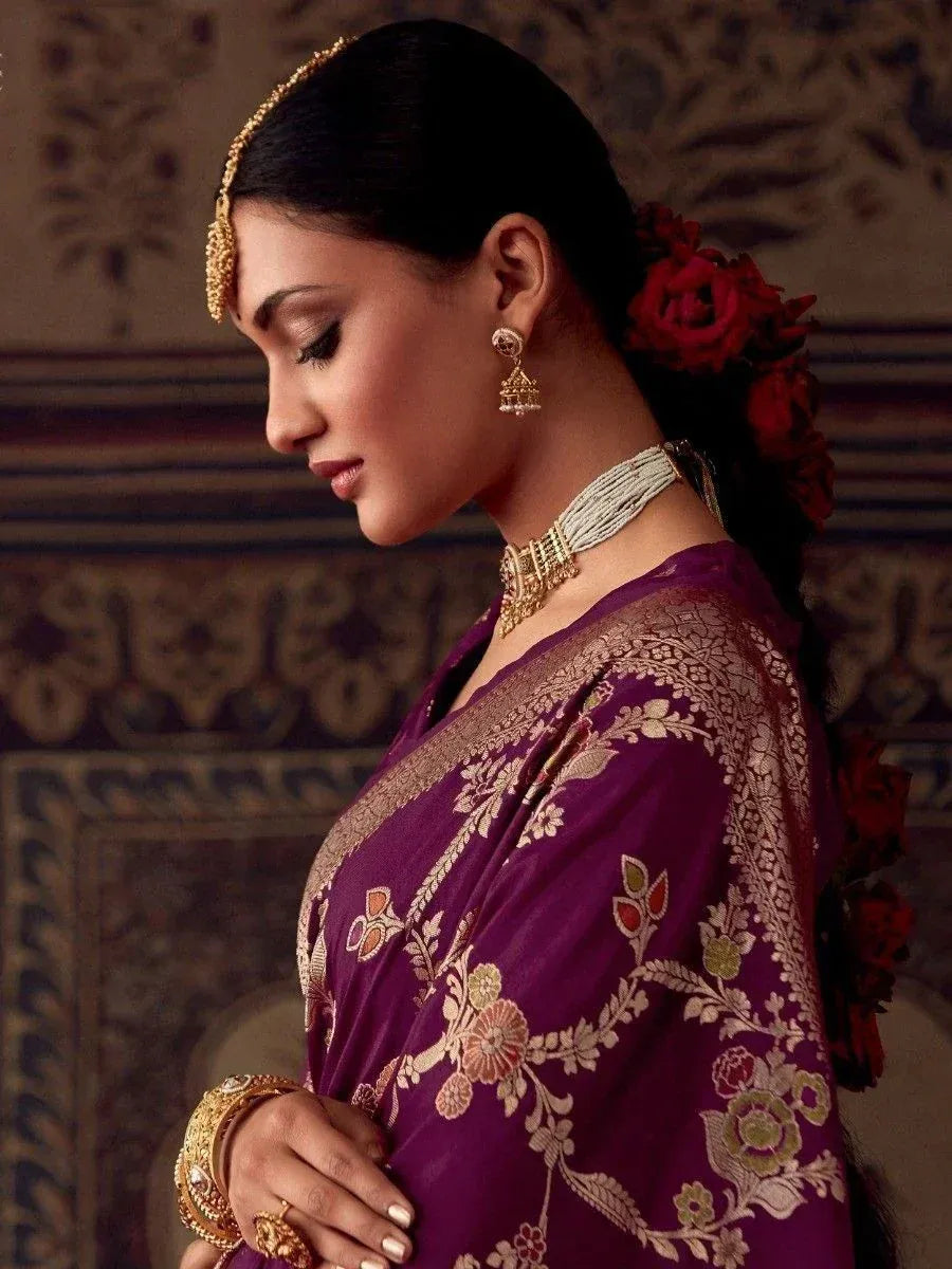 Purple floral embroidered saree with gold jewelry and red roses in hair, traditional Indian ethnic wear