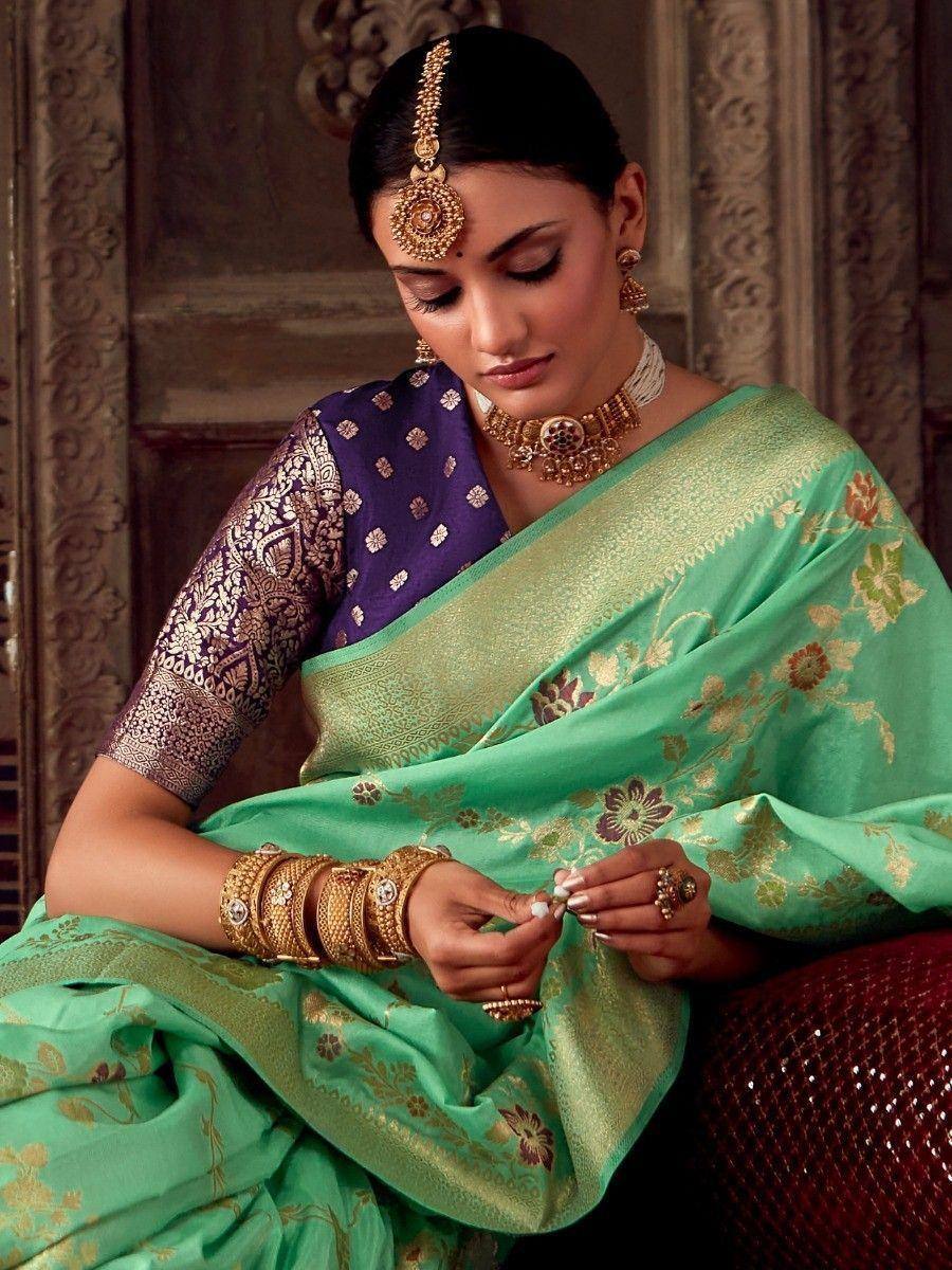 Elegant woman in green floral saree with purple blouse, traditional Indian jewelry, perfect for ethnic occasions