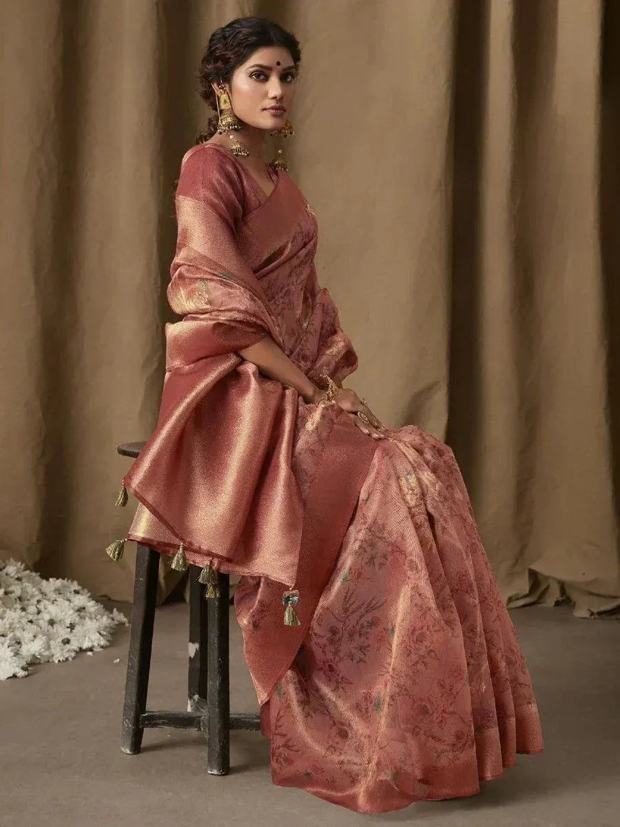 Elegant pink floral saree with gold tassels, styled with traditional jewelry for ethnic occasions