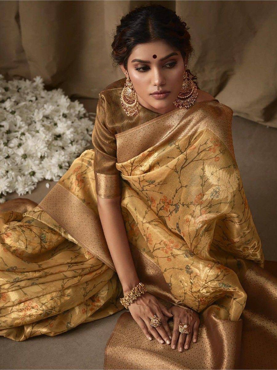 Elegant gold floral saree with traditional jewelry, perfect for Indian ethnic occasions
