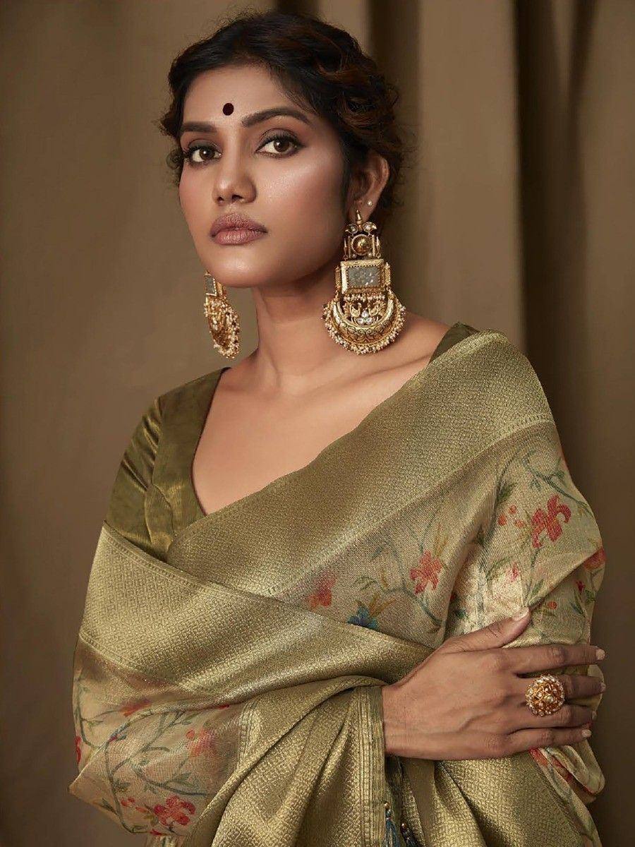 Elegant woman in golden floral saree with traditional gold jewelry, showcasing Indian ethnic wear