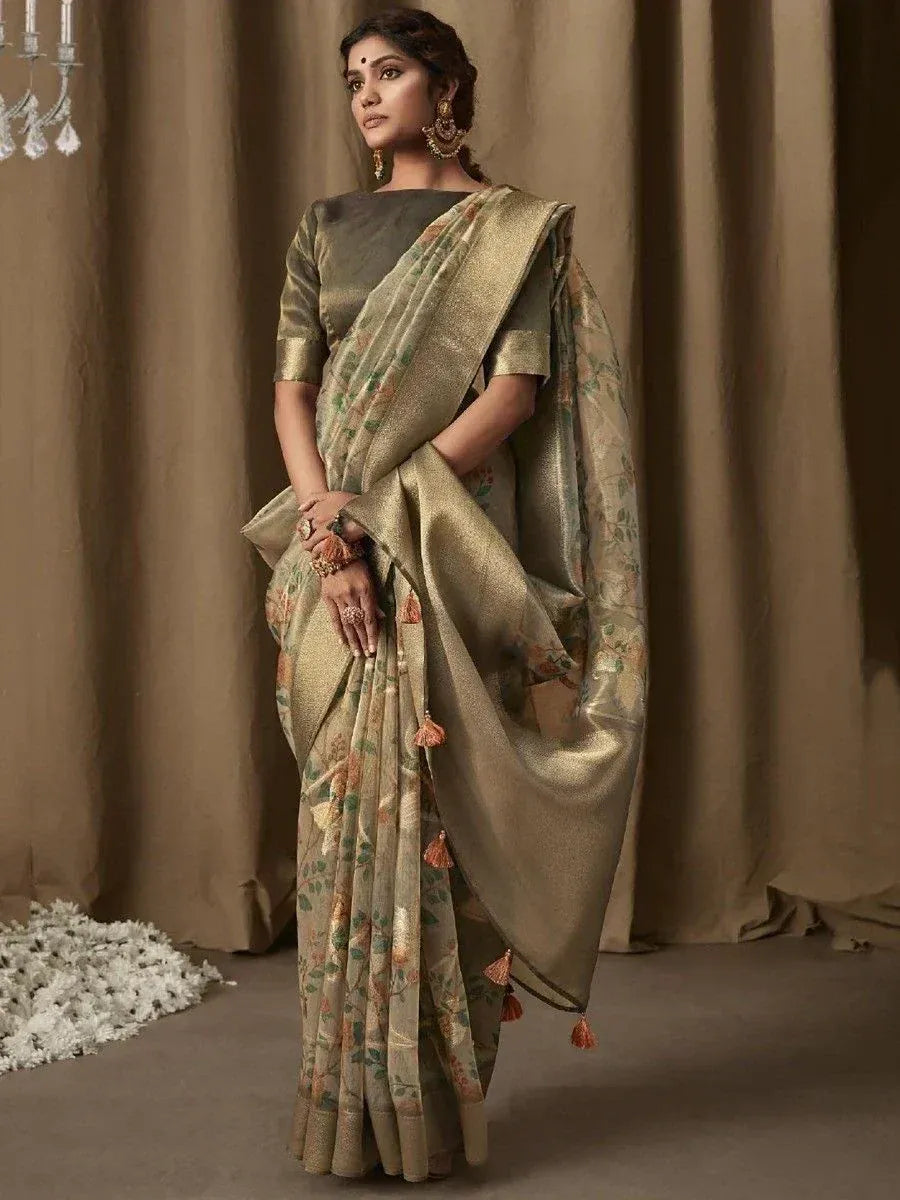 Elegant olive green floral saree with gold border and tassels, paired with matching blouse for Indian ethnic wear