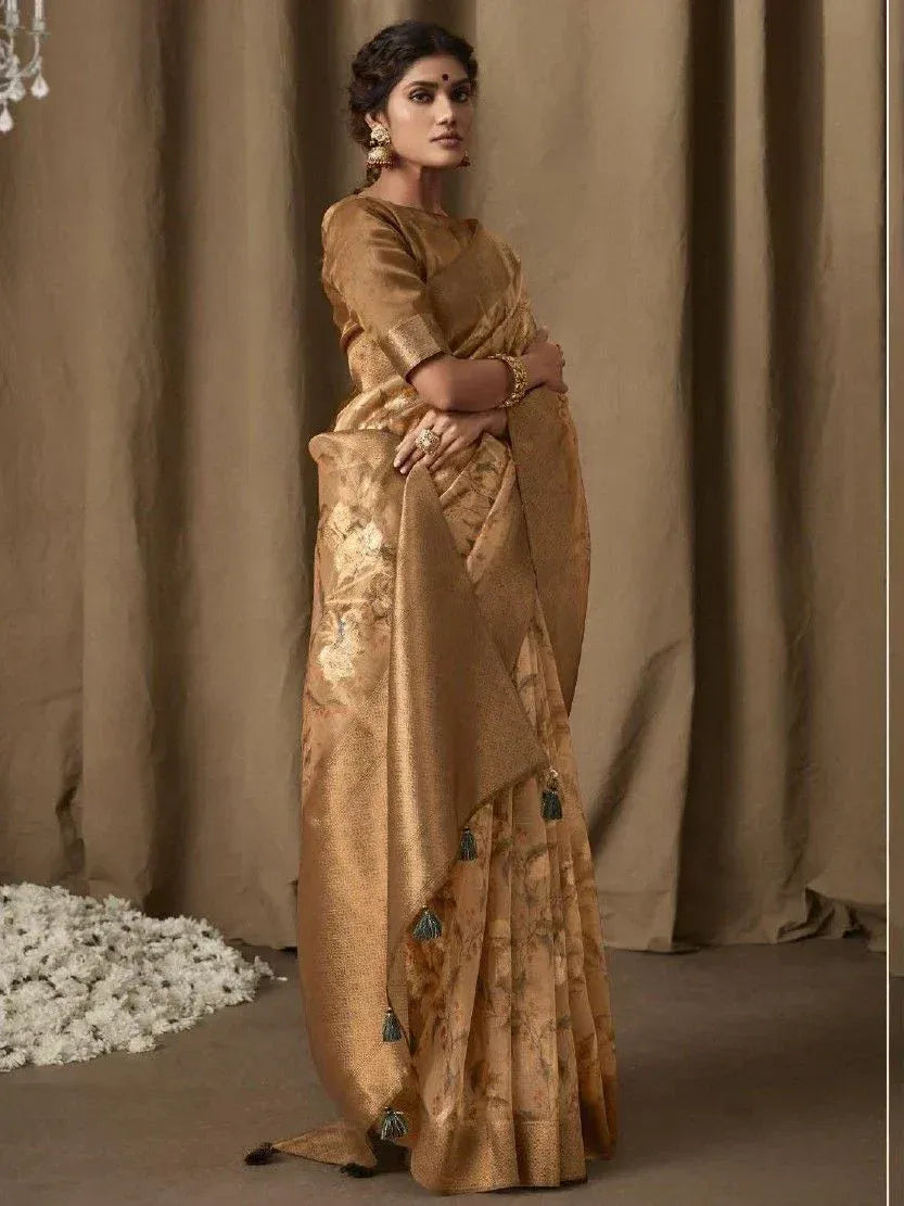 Elegant gold designer saree with floral print and tassels, perfect for Indian ethnic occasions