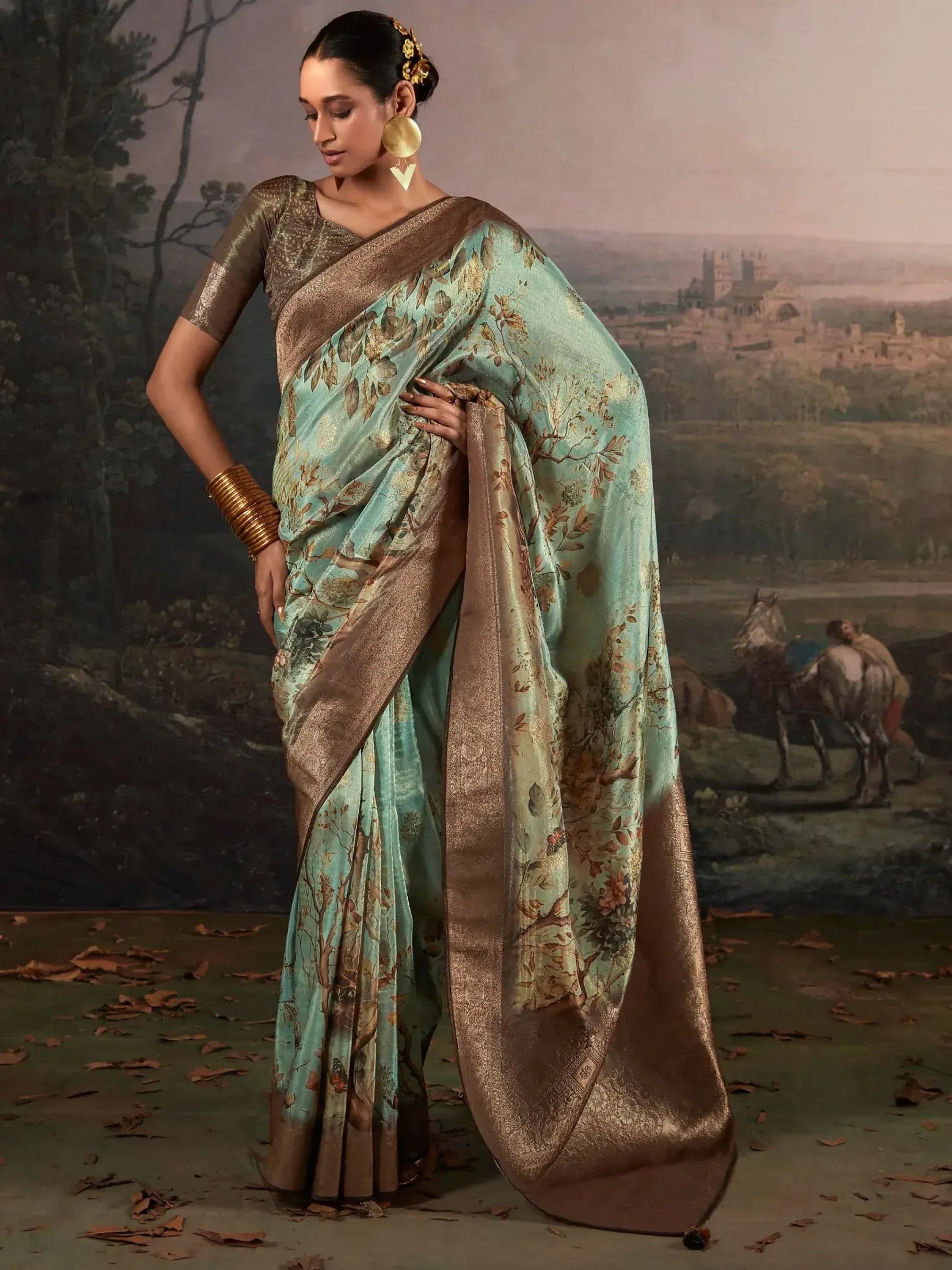 Elegant mint green saree with gold floral print and border, paired with matching blouse for ethnic wear