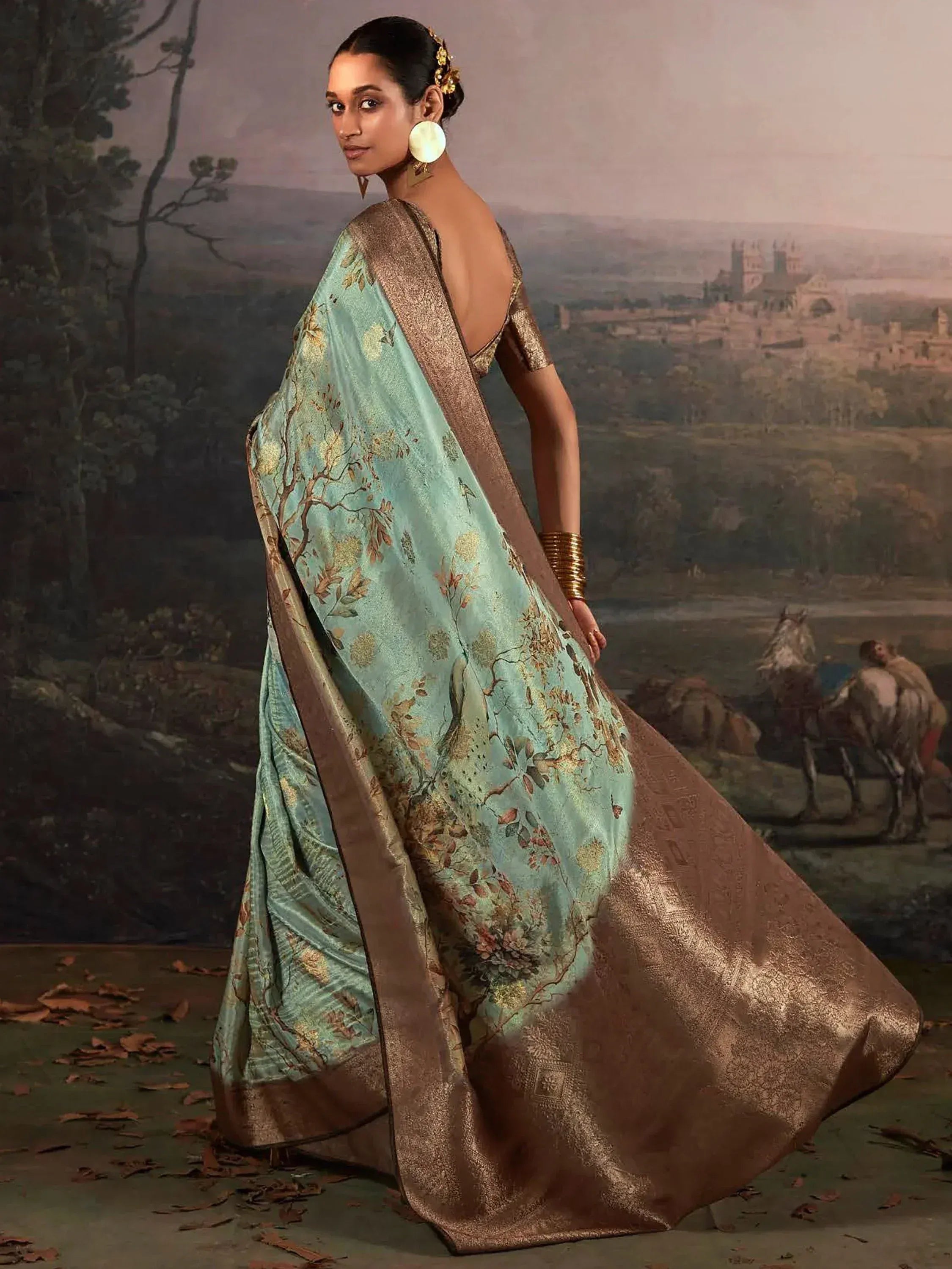 Elegant mint green saree with gold floral print and metallic border, perfect for Indian ethnic occasions.