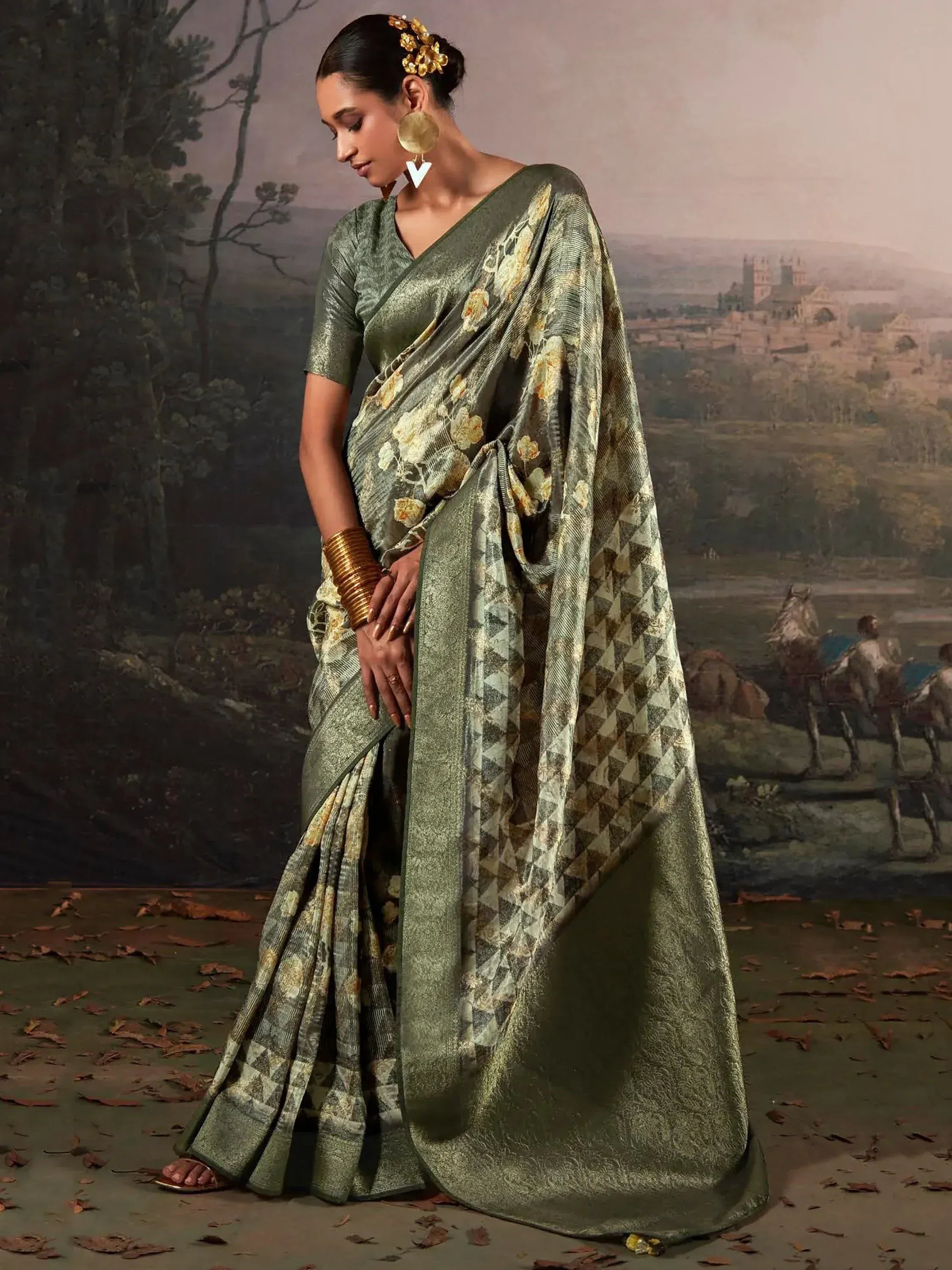 Olive green floral and geometric print saree with matching blouse, styled with gold jewelry for ethnic wear.