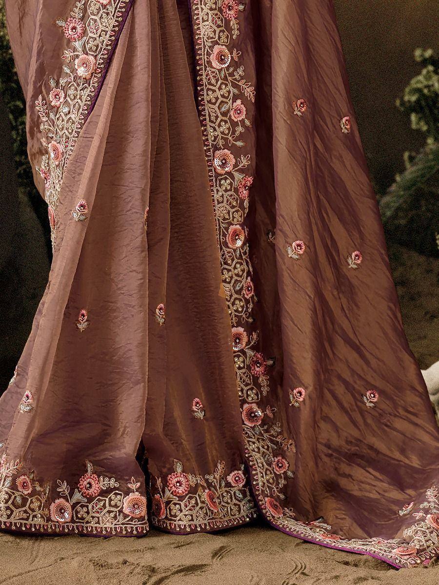 Brown ethnic saree with pink floral embroidery and gold detailing, perfect for Indian weddings and festivals