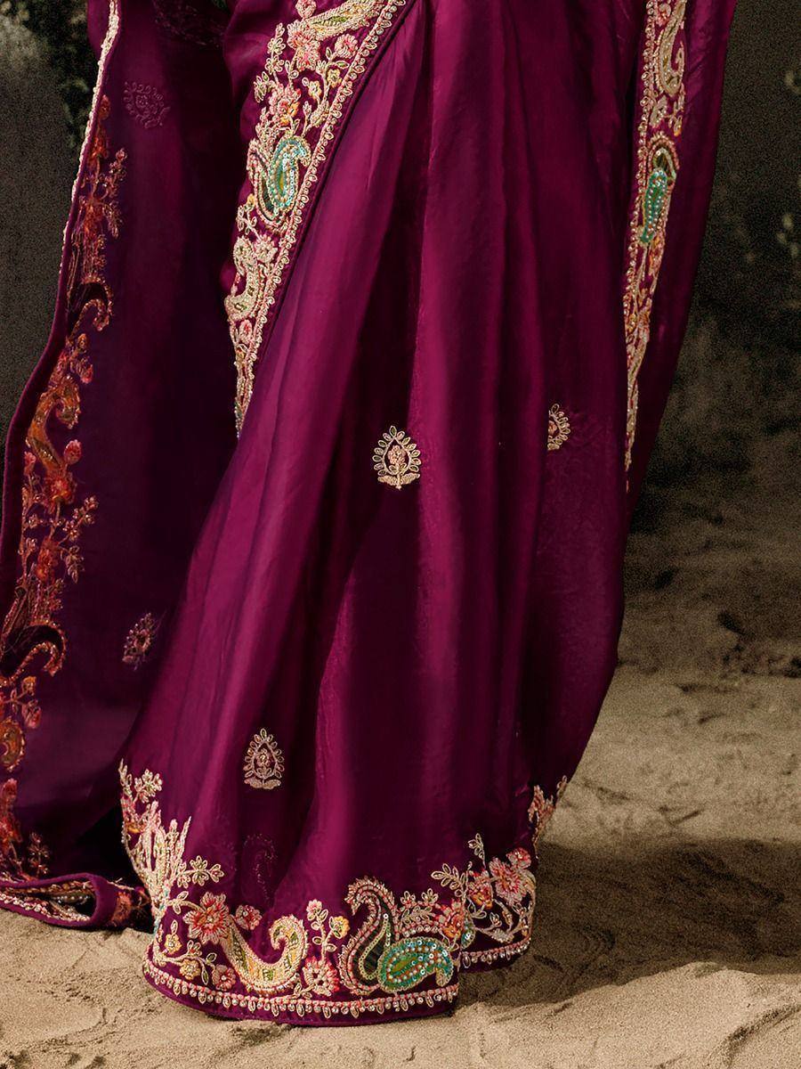 Rich purple Indian saree with intricate floral and paisley embroidery, perfect for ethnic occasions.