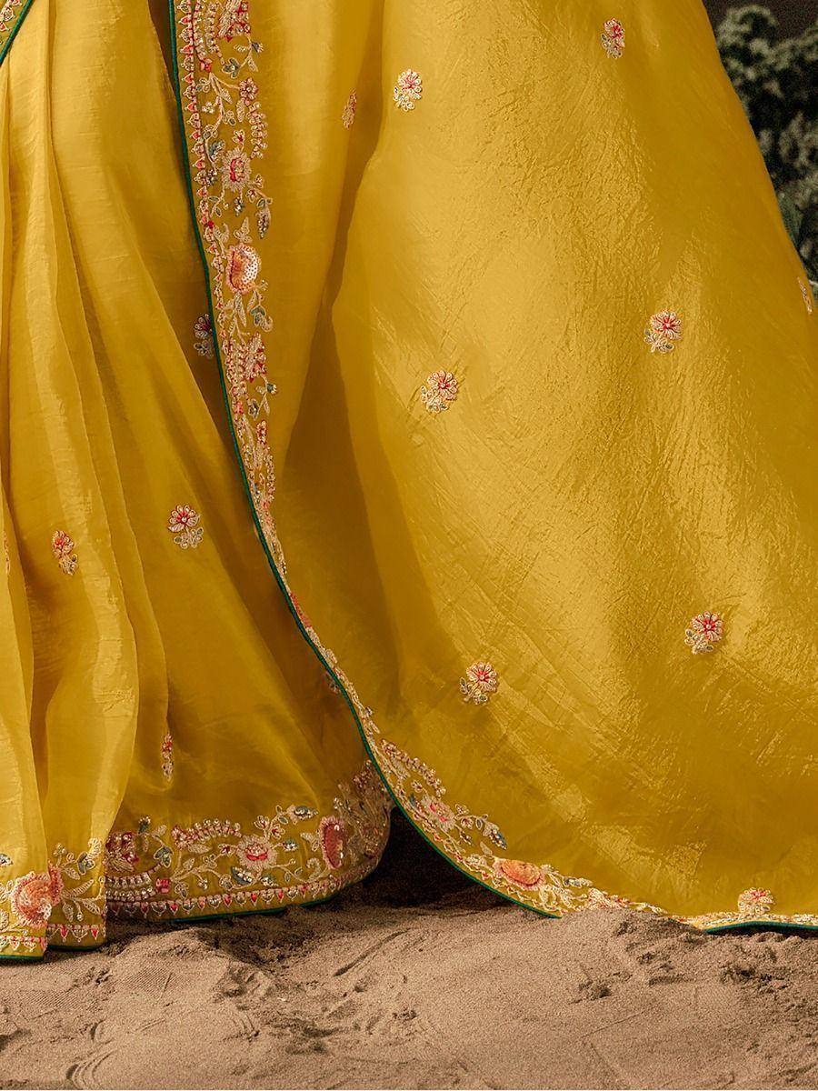 Yellow ethnic saree with floral embroidery and green border, perfect for Indian festive occasions