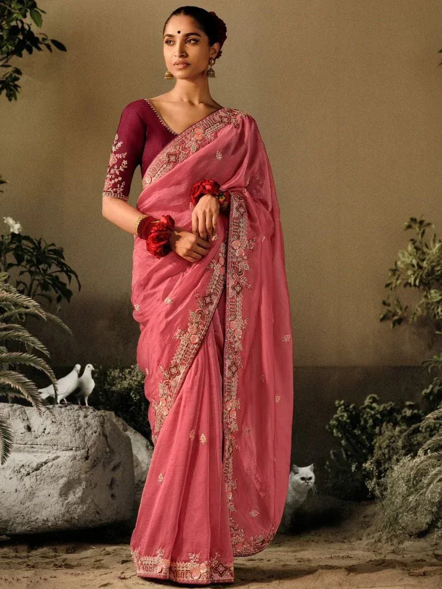 Pink embroidered saree with matching blouse, floral border, and traditional Indian styling for ethnic occasions