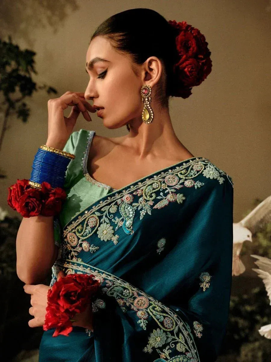 Elegant teal saree with floral embroidery, red roses, and blue bangles for Indian ethnic wear