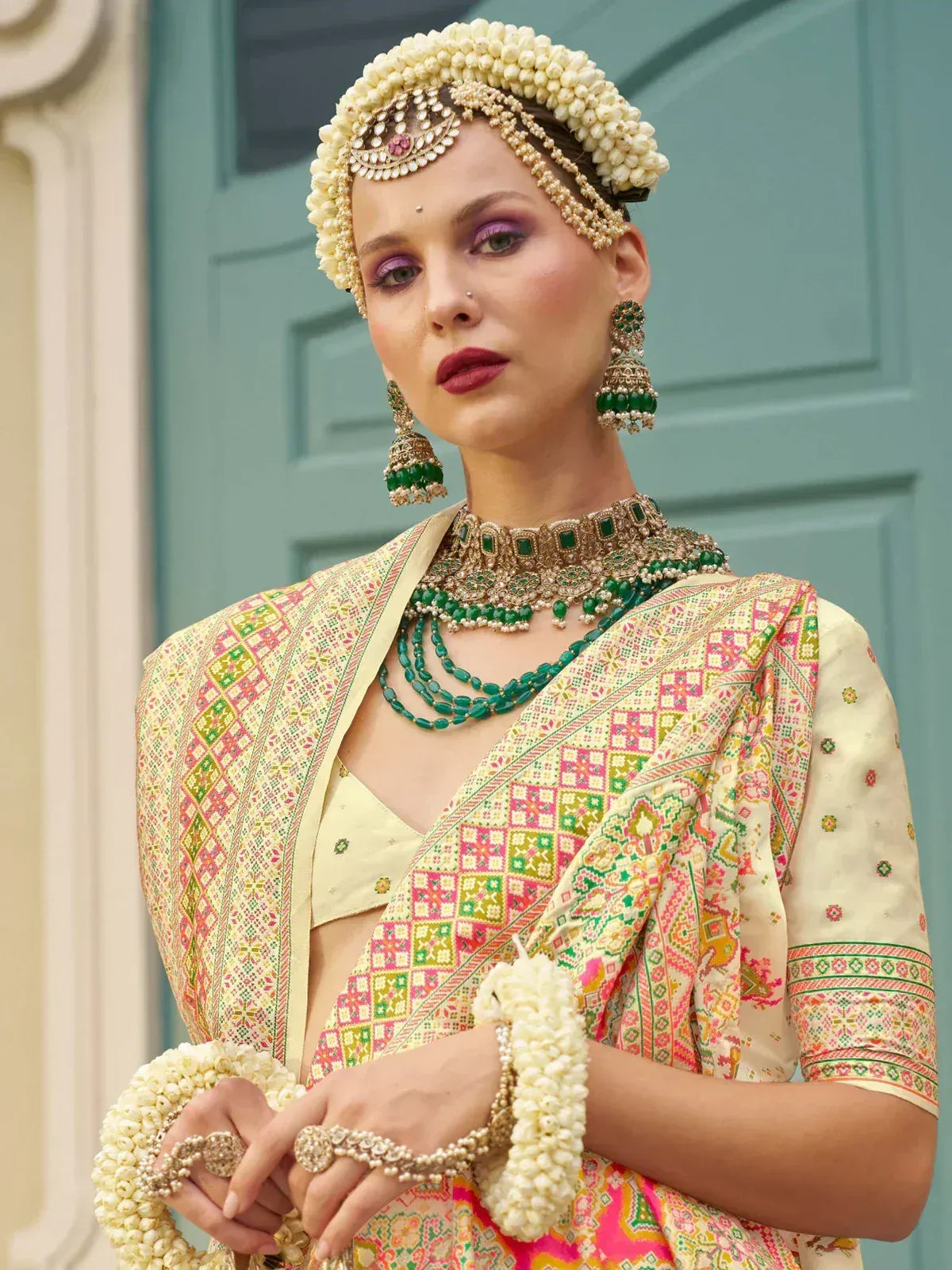 Indian bridal lehenga choli with floral jewelry and colorful embroidery, perfect for weddings and festivals.