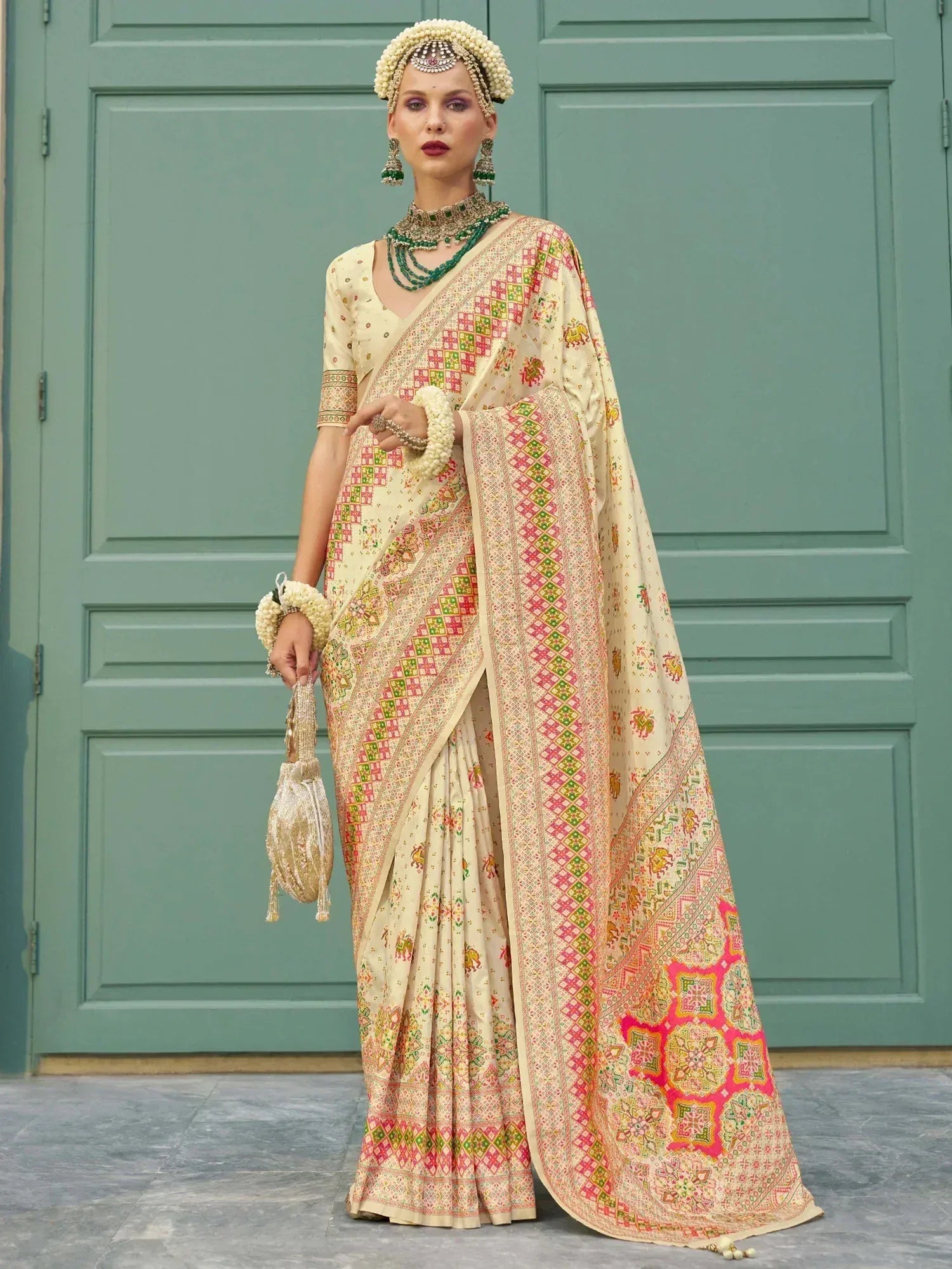 Cream saree with pink green geometric print, ethnic jewelry, floral headpiece, traditional Indian wedding wear