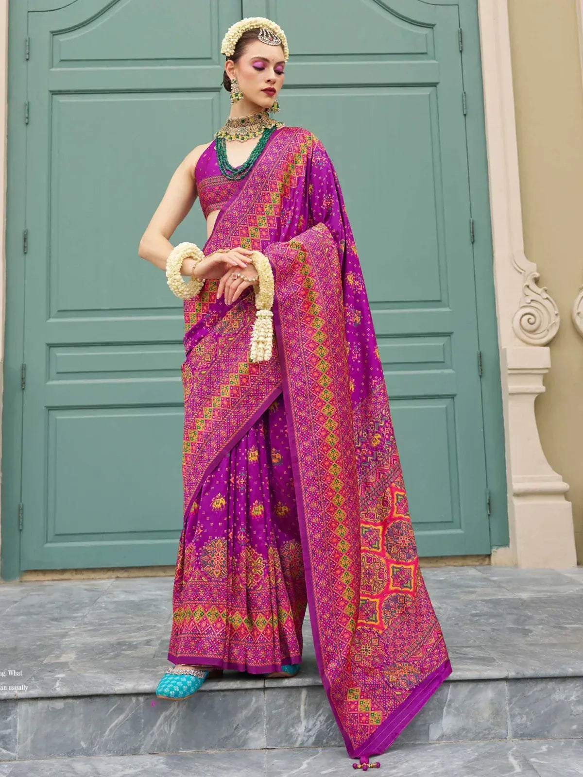 Vibrant purple printed saree with ethnic jewelry, perfect for Indian festive occasions