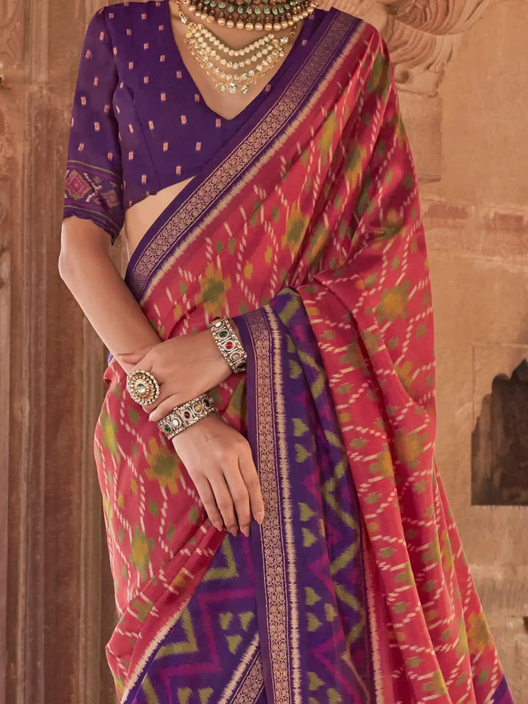 Bewitching Coral Red Patola Printed Georgette Saree With Purple Blouse
