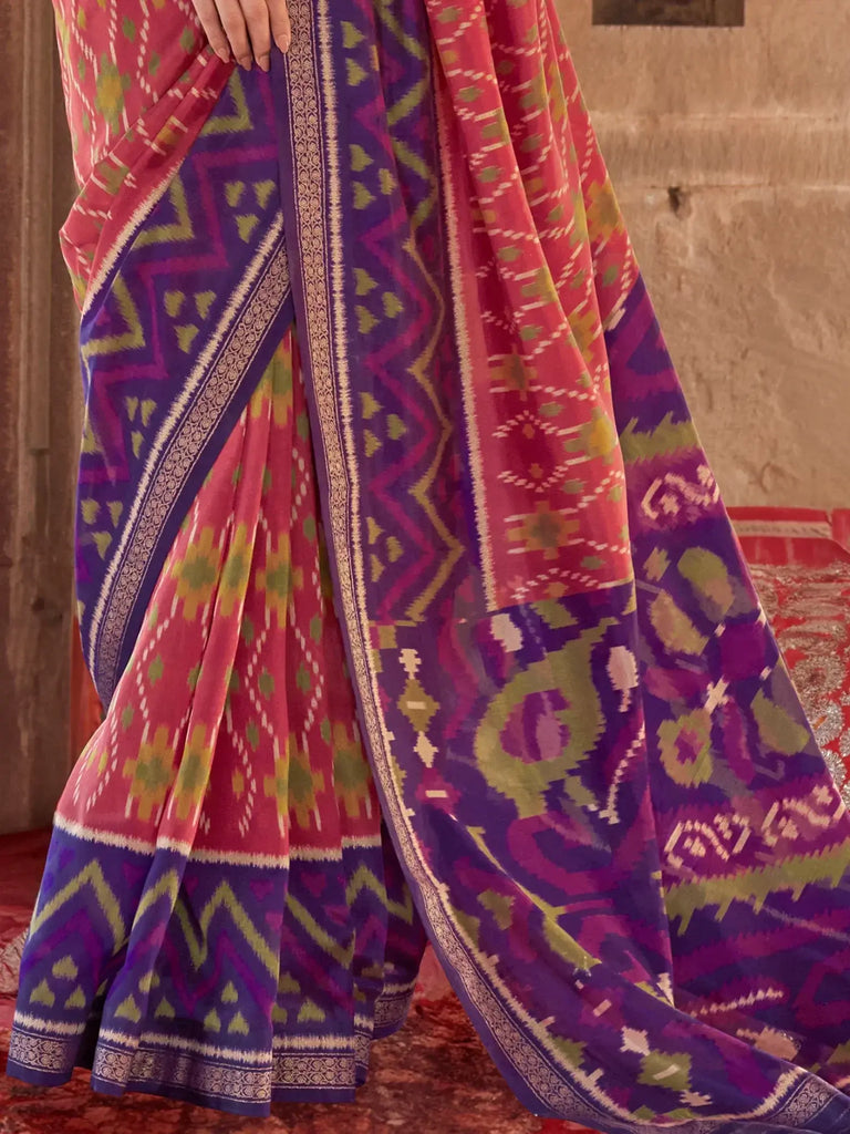 Bewitching Coral Red Patola Printed Georgette Saree With Purple Blouse