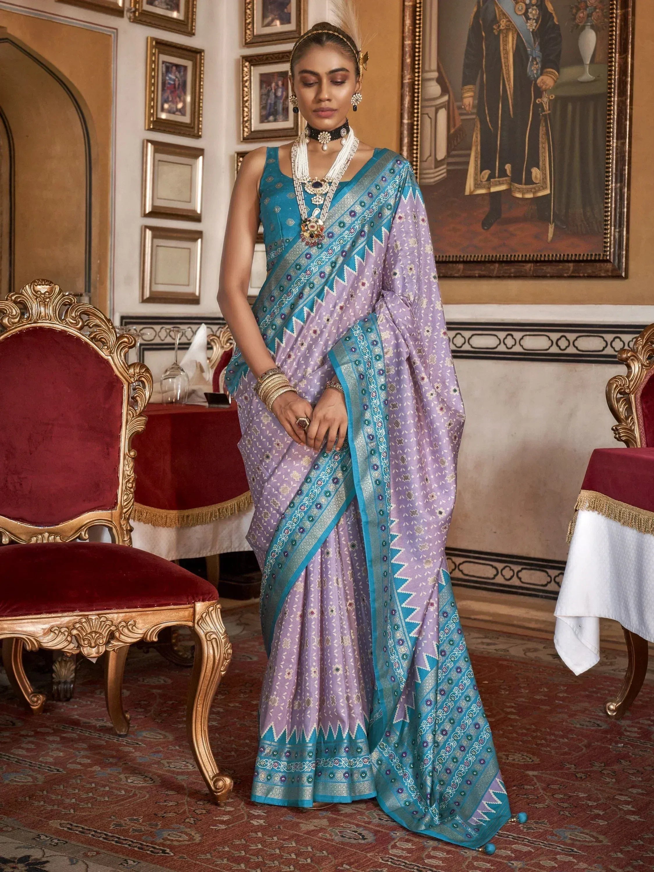 Elegant lavender and teal designer saree with intricate embroidery, perfect for Indian ethnic wear occasions.