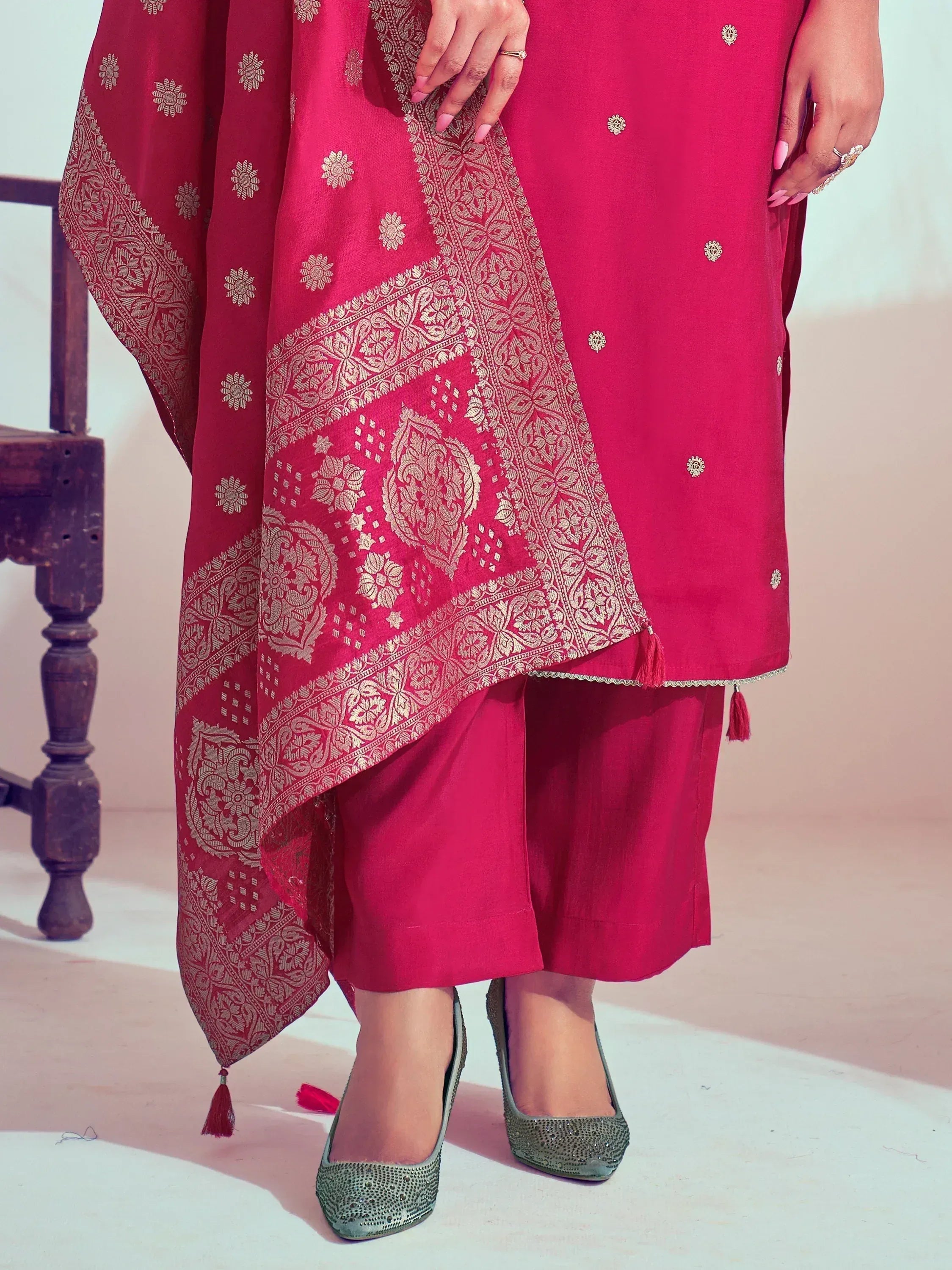 Pink ethnic salwar kameez with gold floral embroidery and matching dupatta, styled with embellished heels