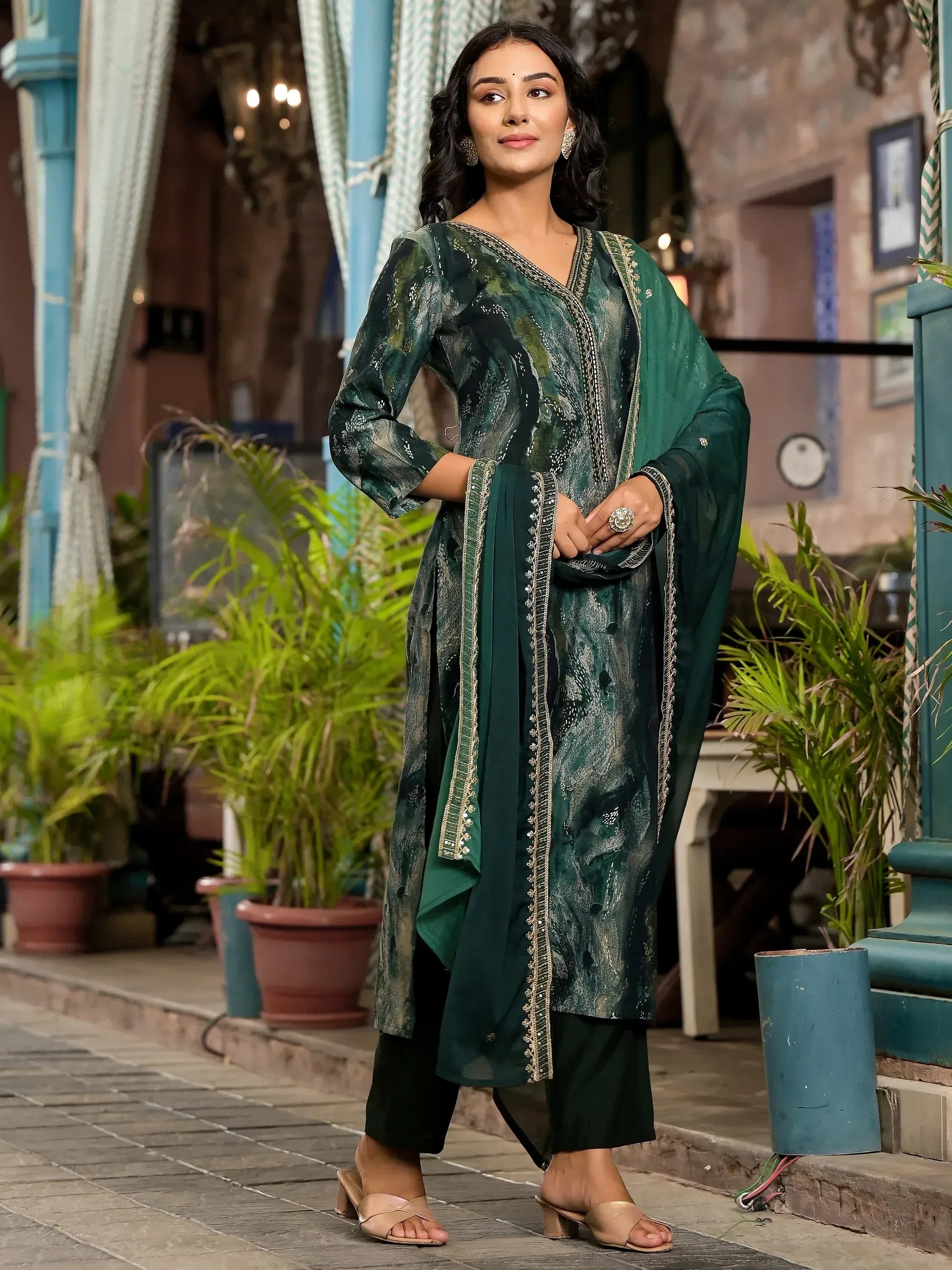 Emerald green printed kurta with gold embroidery, paired with palazzo pants and dupatta for ethnic wear