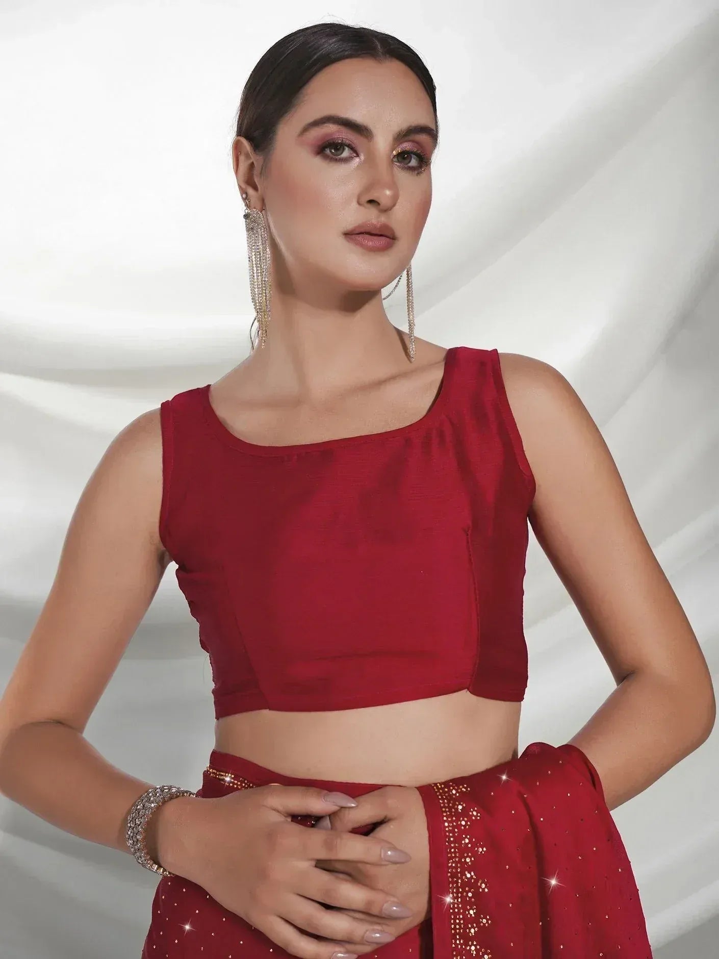 Red sleeveless crop top with matching embellished lehenga, ethnic Indian wear for women