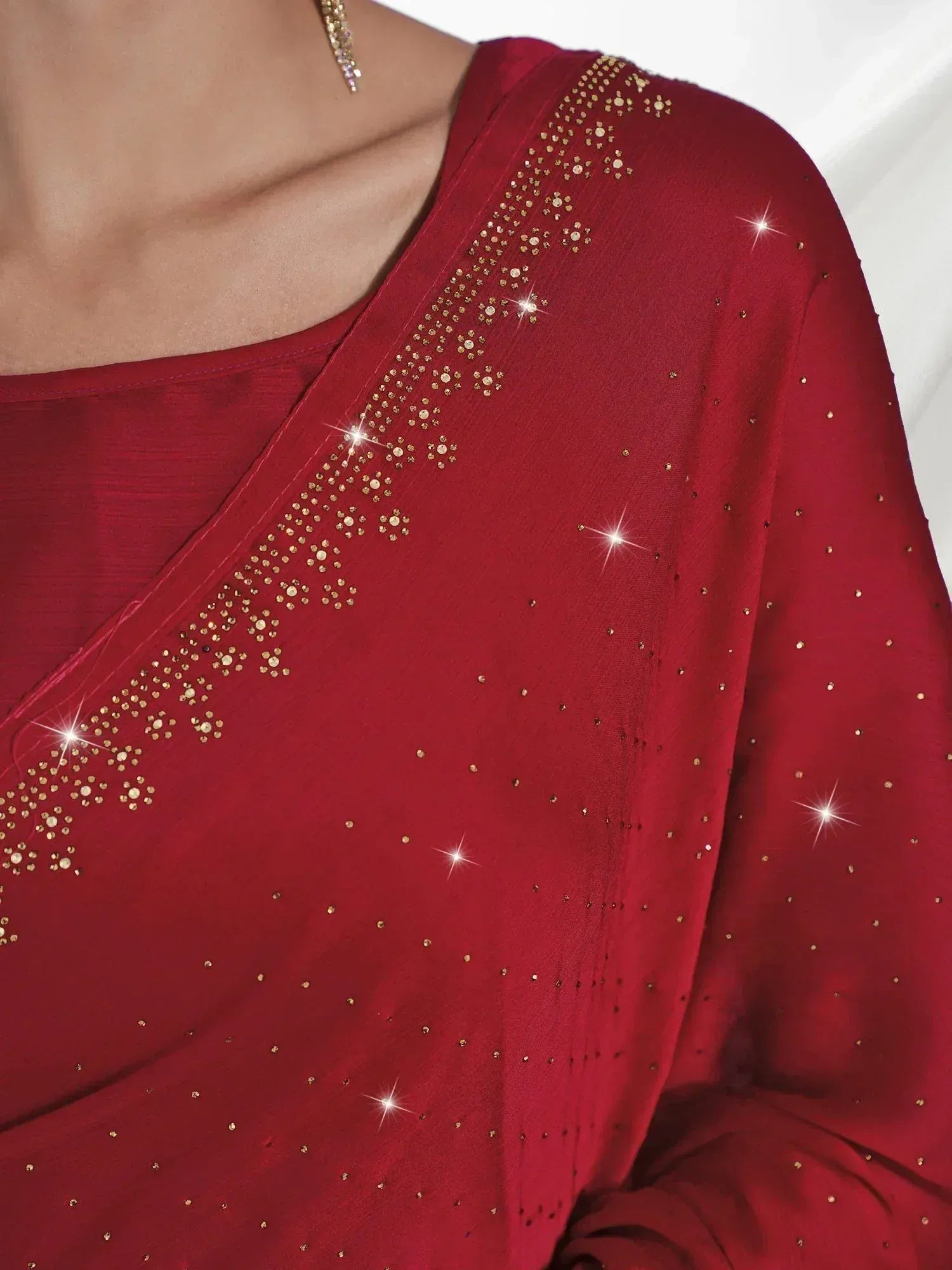 Red ethnic saree with gold sequin embroidery and sparkling details, perfect for festive occasions