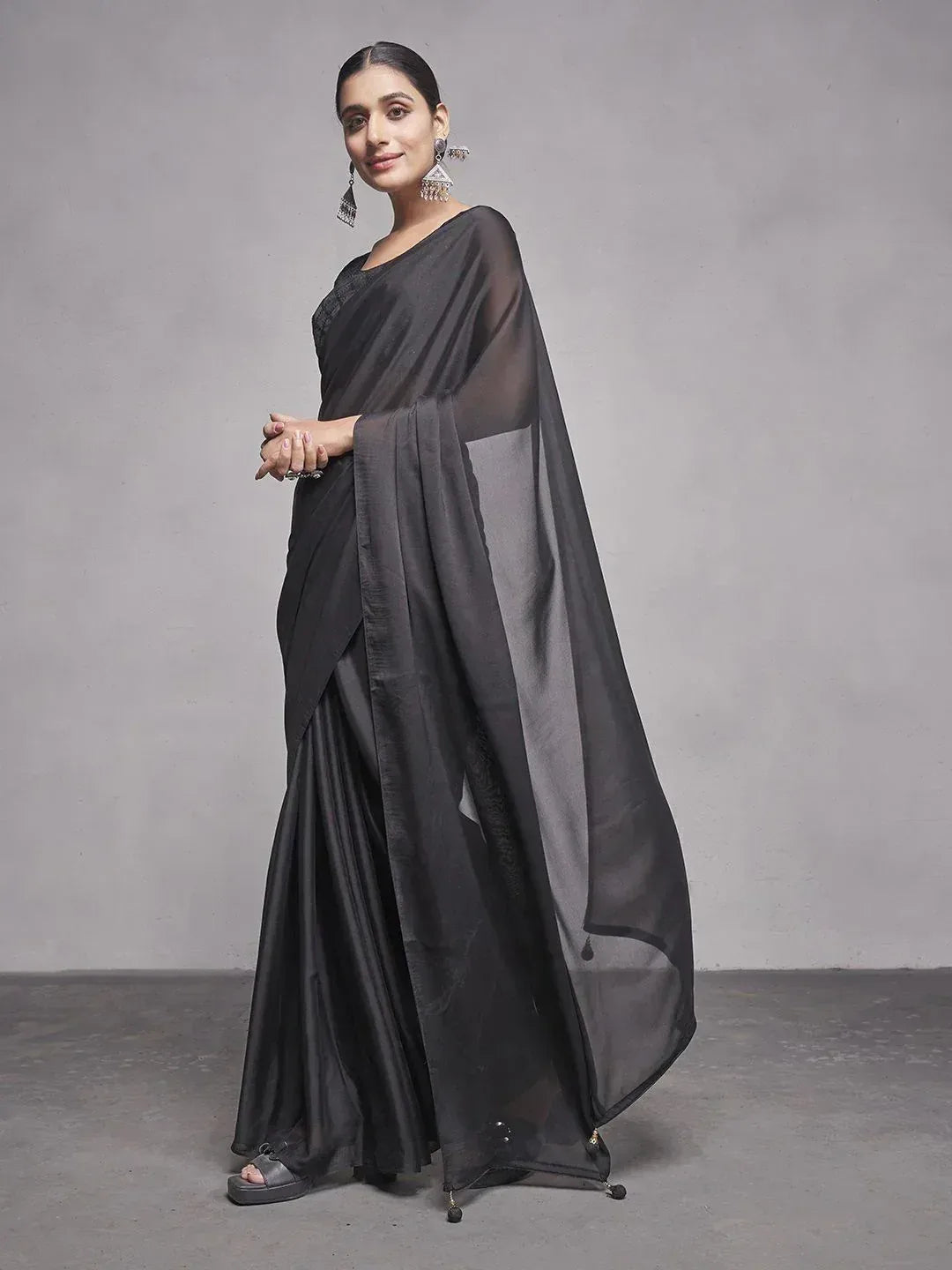 Black designer saree with sheer blouse and elegant drape, perfect for ethnic occasions