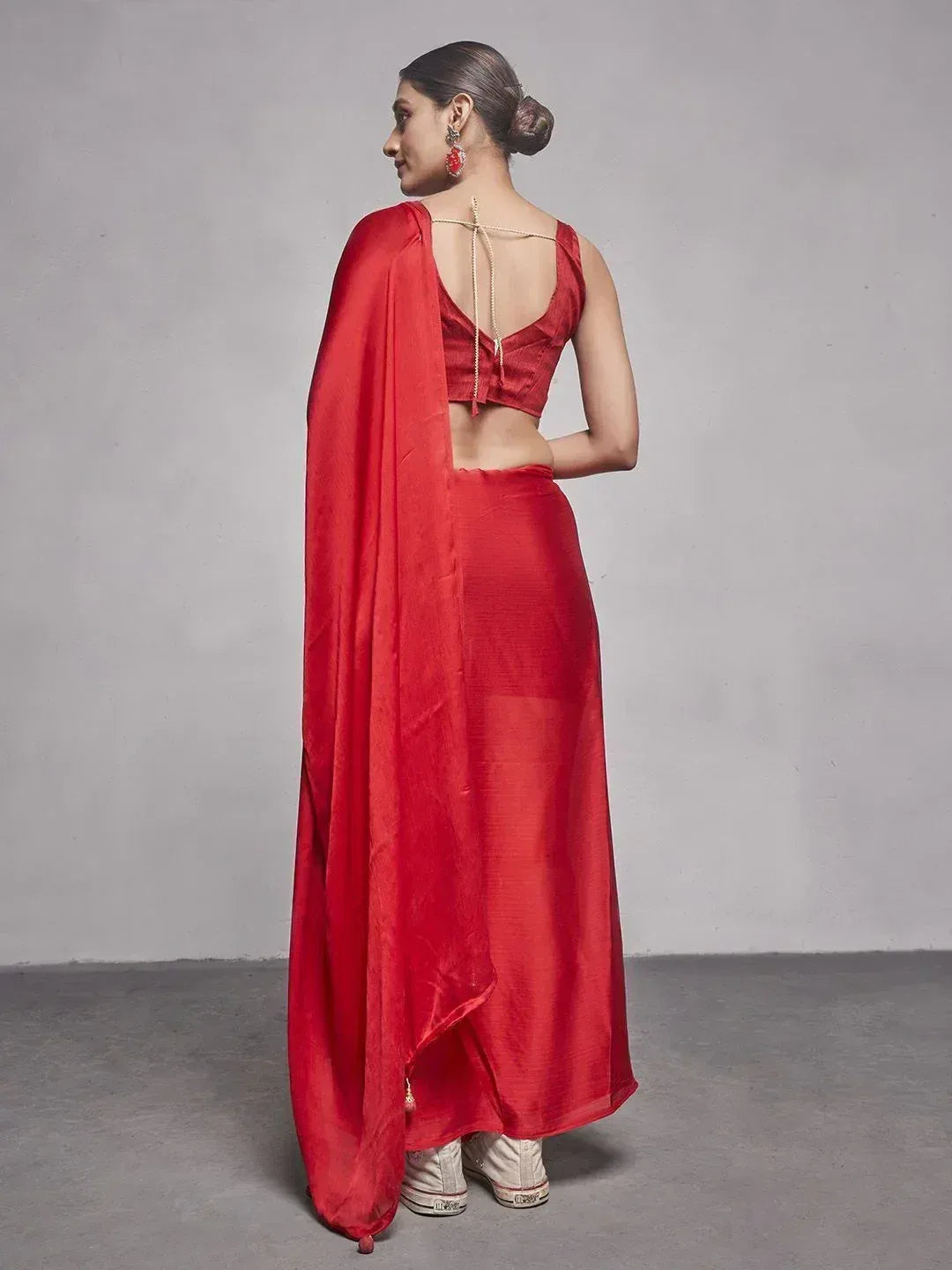 Red ethnic saree with backless blouse and gold detailing, perfect for Indian occasions