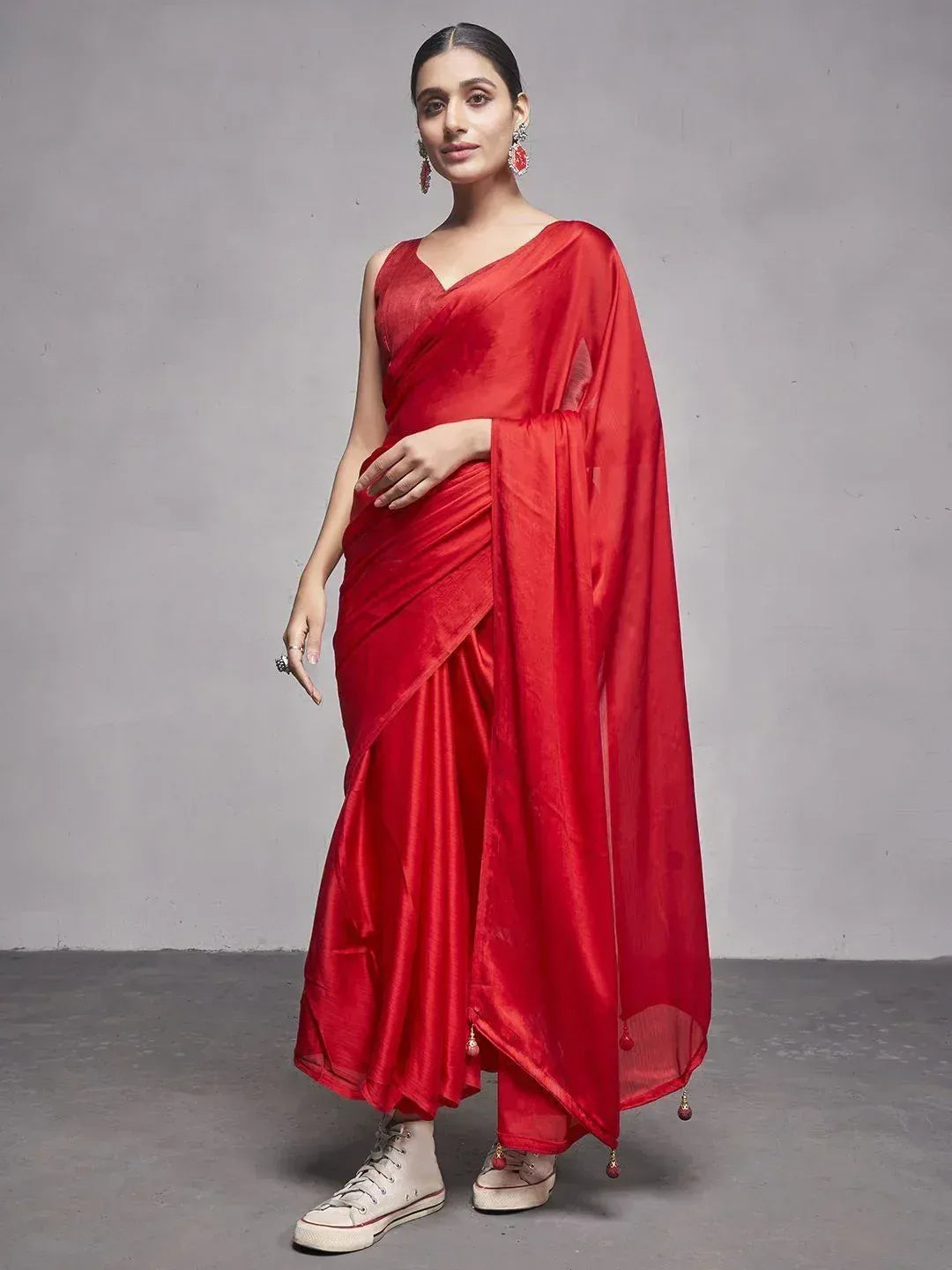Red silk saree with V-neck blouse, paired with sneakers for modern ethnic look