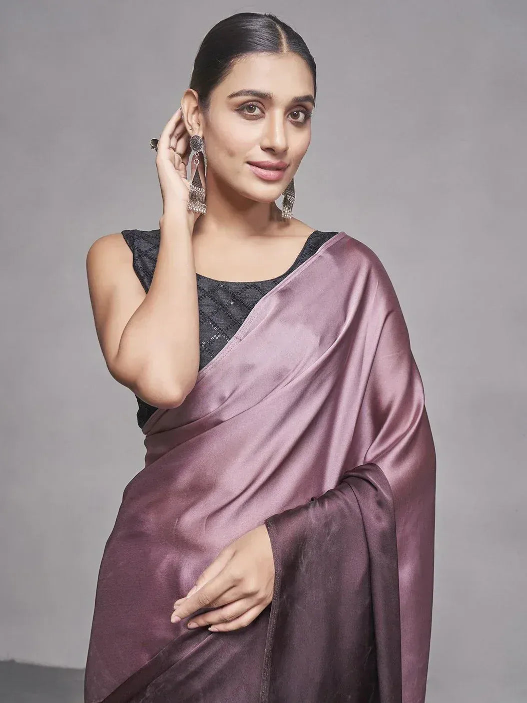 Woman in elegant mauve satin saree with black blouse, perfect for Indian ethnic occasions